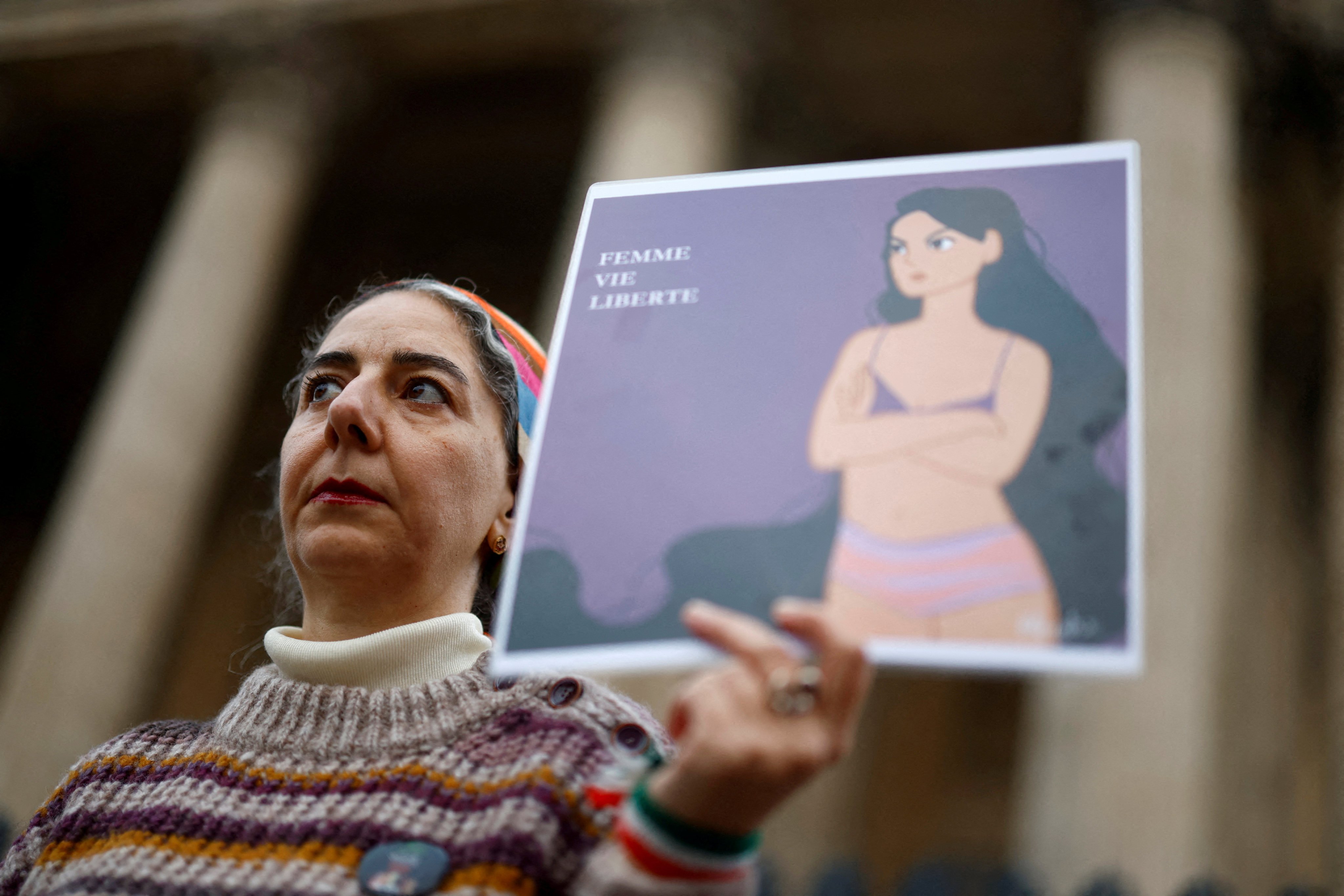 A woman in Paris, France on Tuesday holds a placard in support of an Iranian female student seen in her underwear at a Tehran university. The slogan reads “Woman, Life, Freedom”. Photo: Reuters