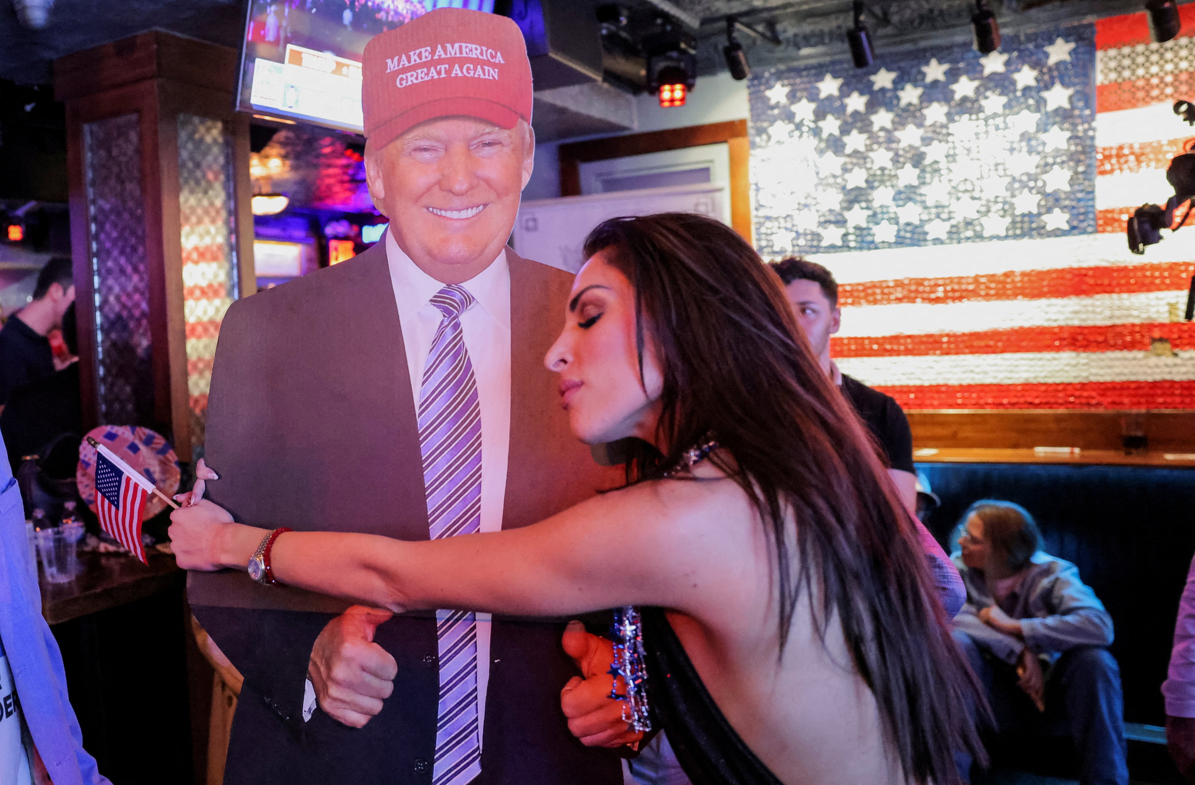 A woman hugs a cardboard cut-out of Donald Trump in New York City. Photo: Reuters