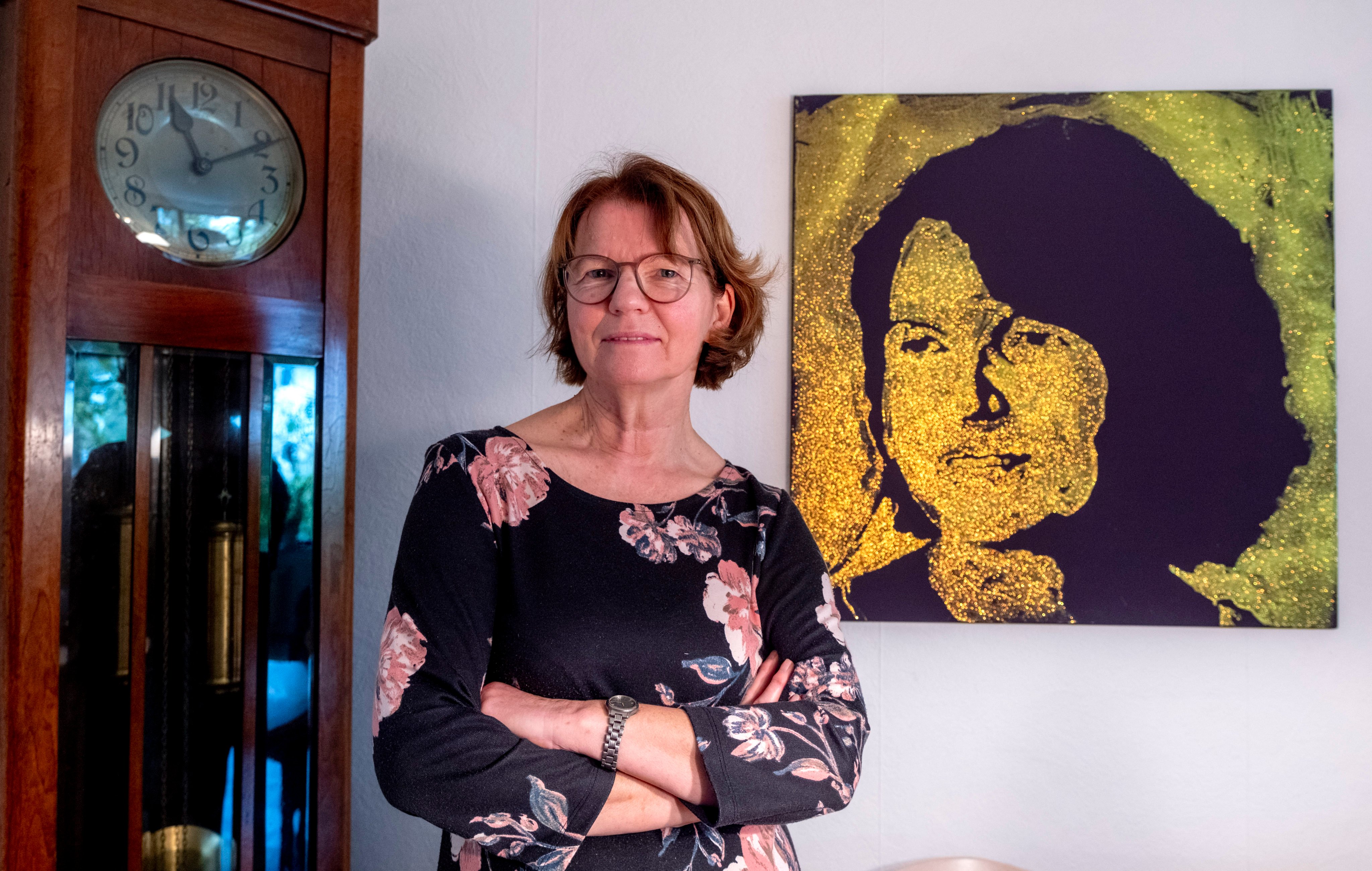 Claudia Huth poses next to a painting showing herself. Photo: AP