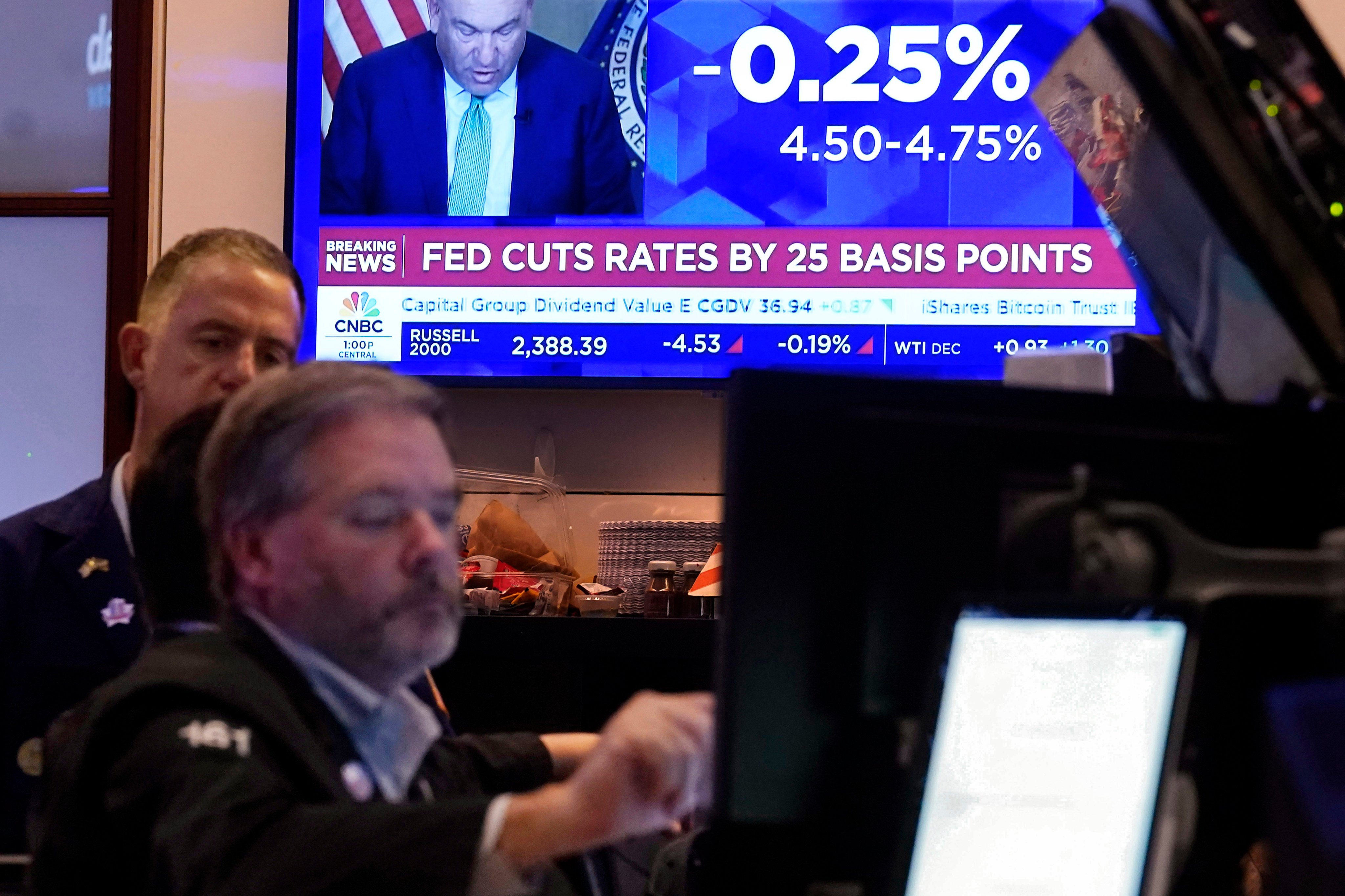 A screen on the floor of the New York Stock Exchange shows the Federal Reserve rate decision on Thursday. Photo: AP