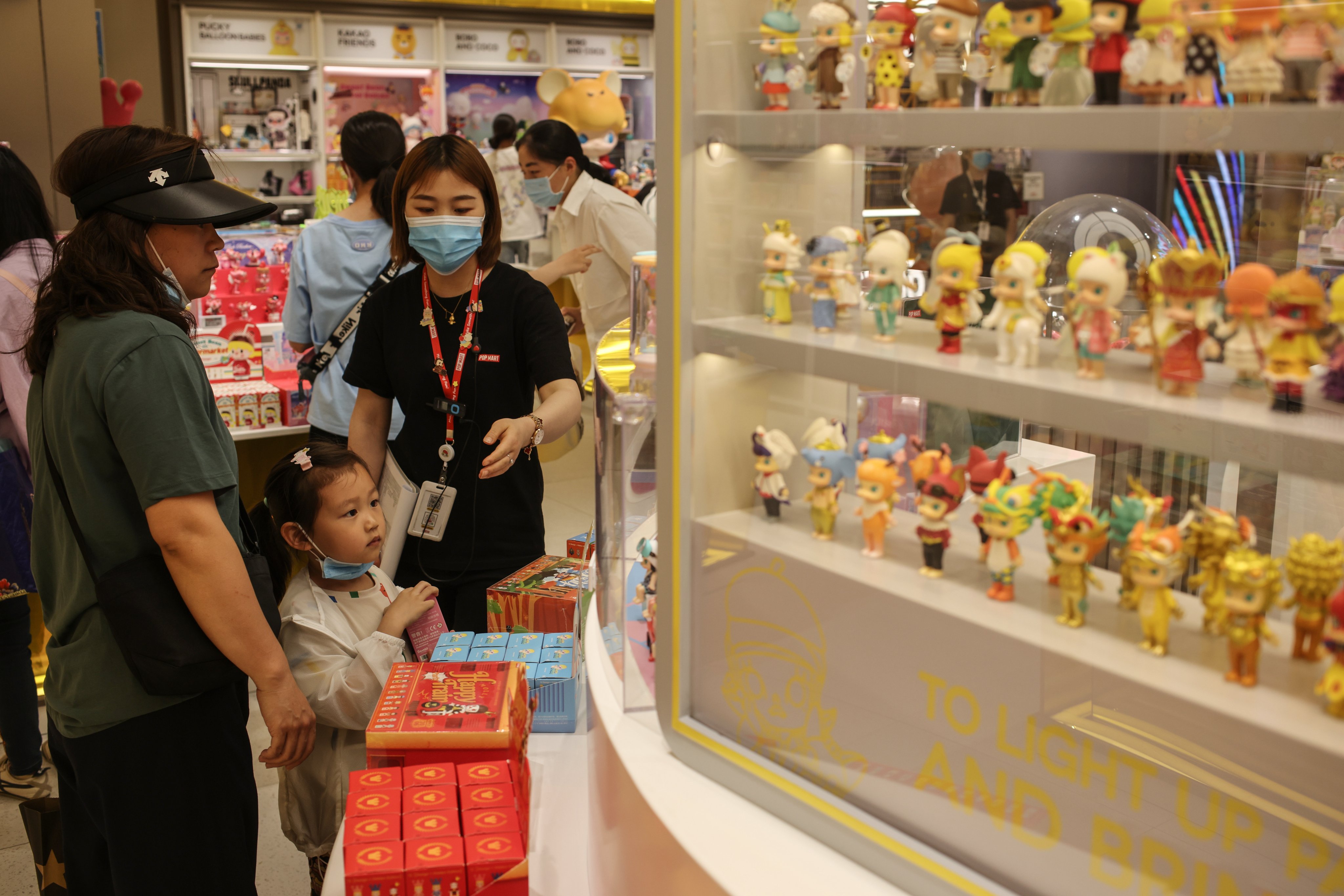 A girl looks at blind boxes in a Pop Mart store in Beijing. Photo: EPA-EFE