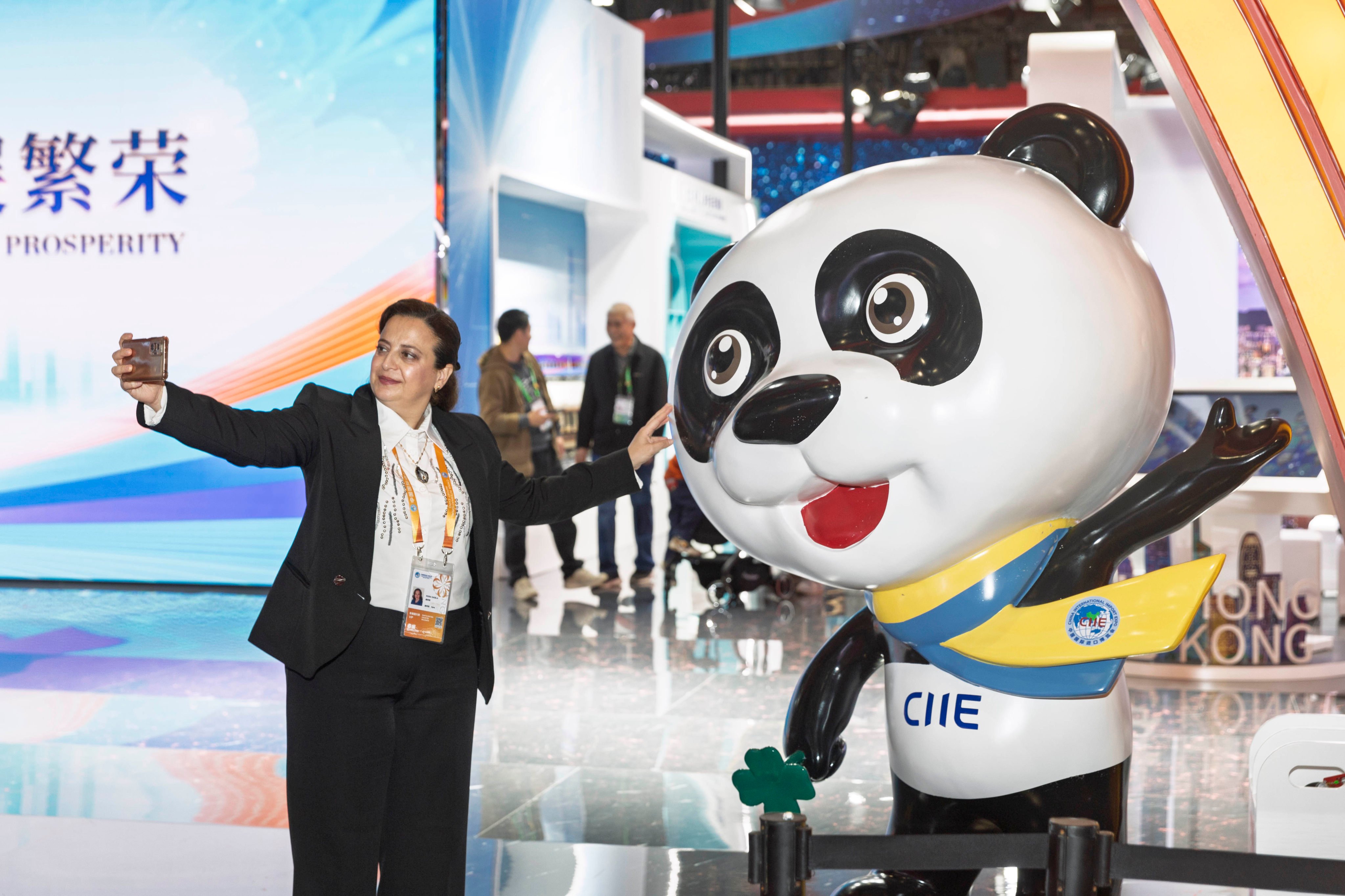 An exhibitor poses for a selfie with a panda mascot at the China International Import Expo in Shanghai this week. Photo: Xinhua