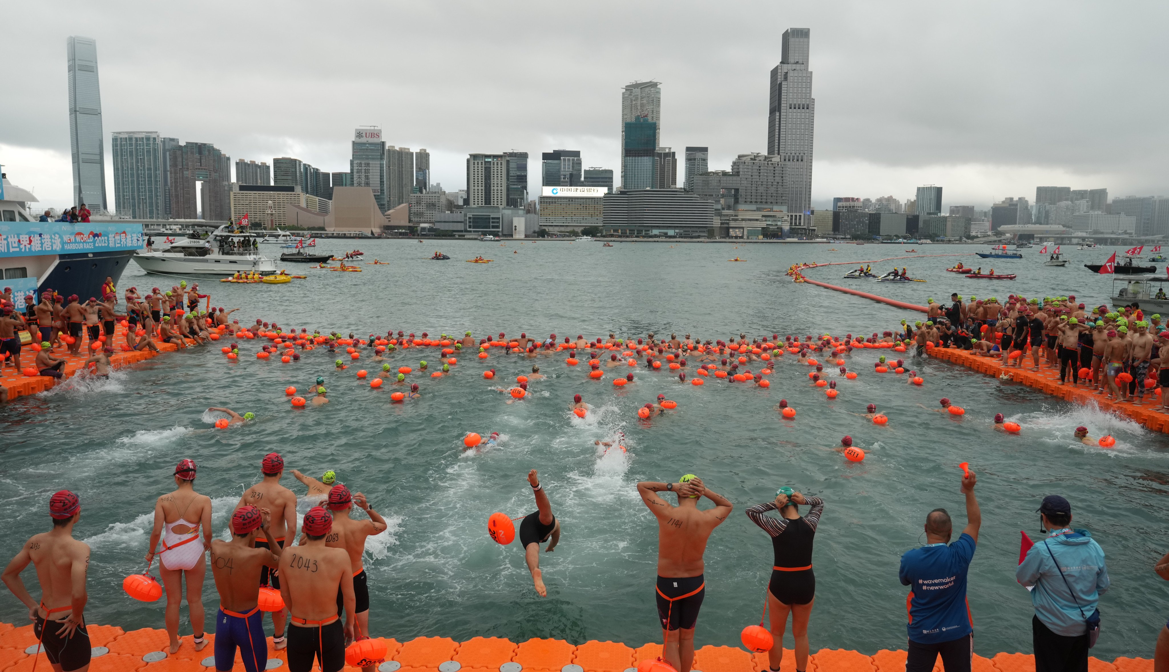 Swimmers take part in the New World Harbour Race last year. The annual race will be cancelled if the No 1 warning signal is in force on Sunday. Photo: Sam Tsang