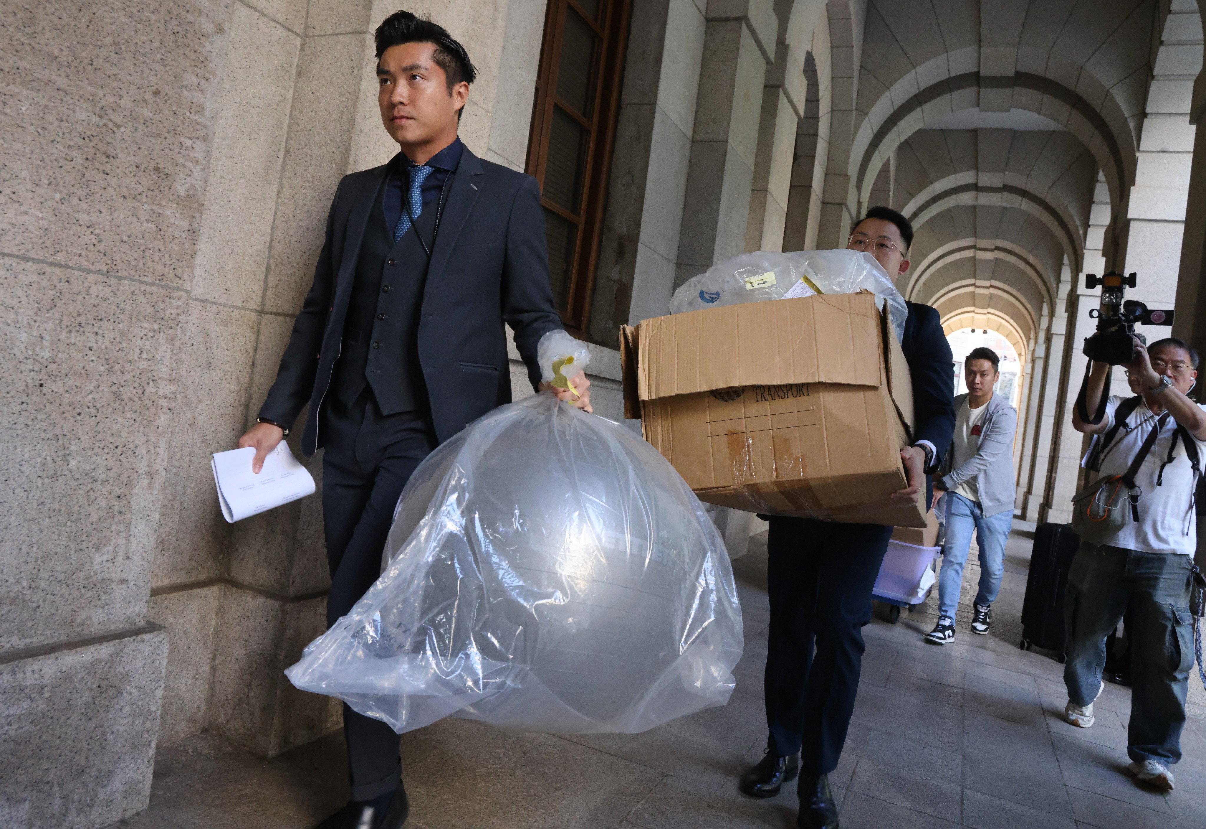 Evidence including a yoga ball is taken from a court after an earlier hearing on the case. Photo: Dickson Lee