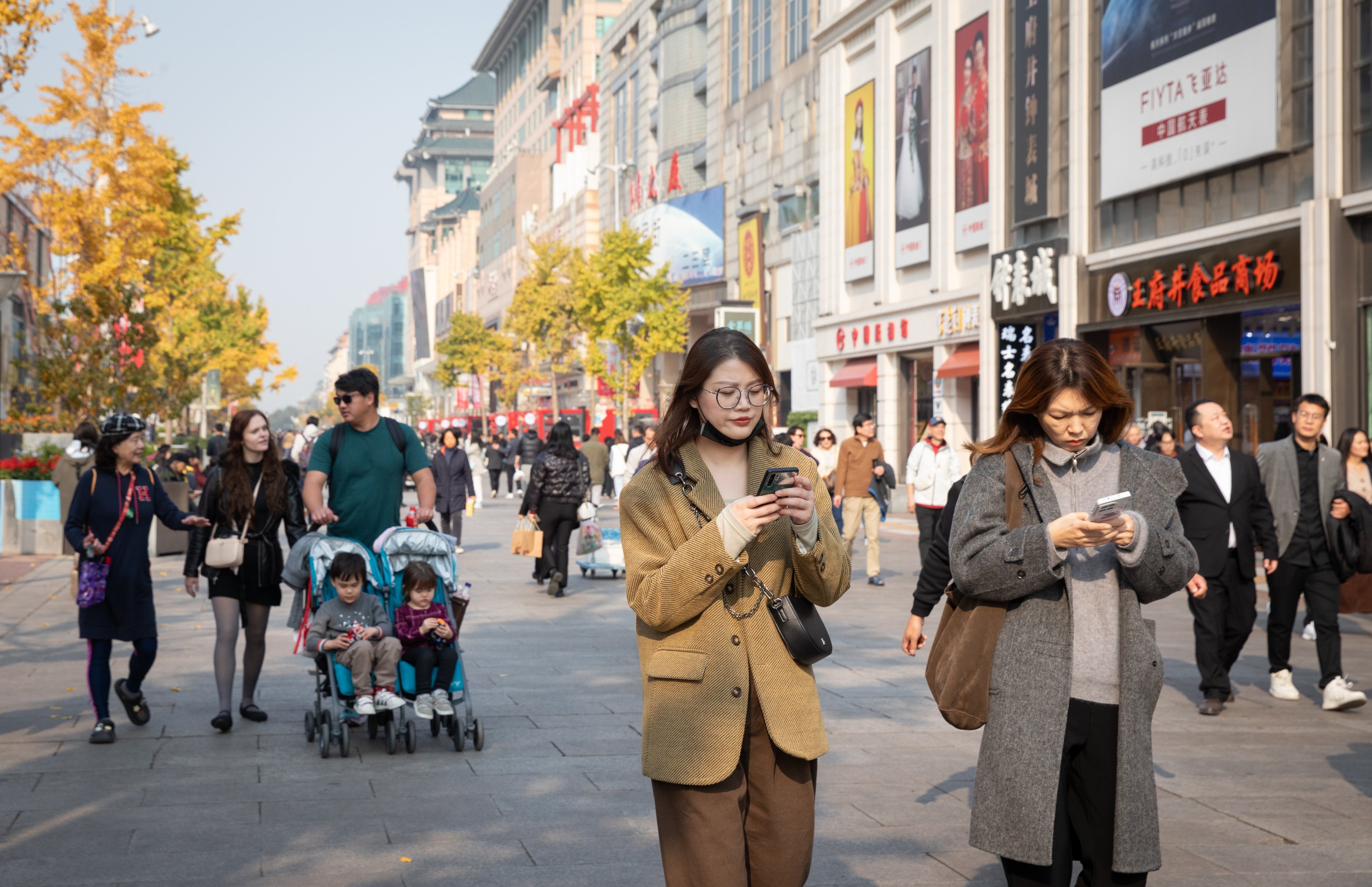 People walk down a shopping street in Beijing, China, on November 7. Photo:  EPA-EFE