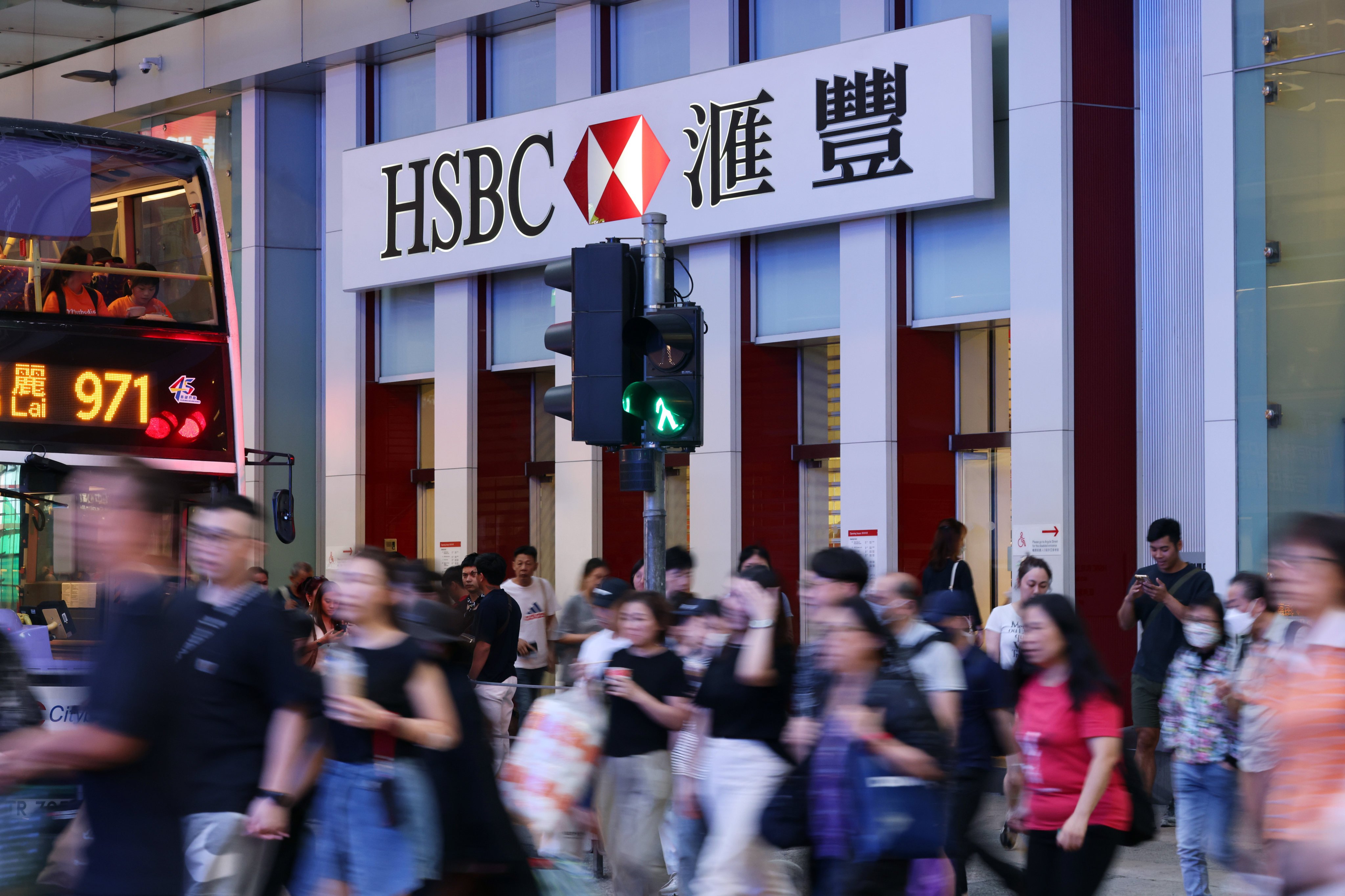 Office workers crossing a busy street near a HSBC branch in Mong Kok on October 22  Photo: Nora Tam