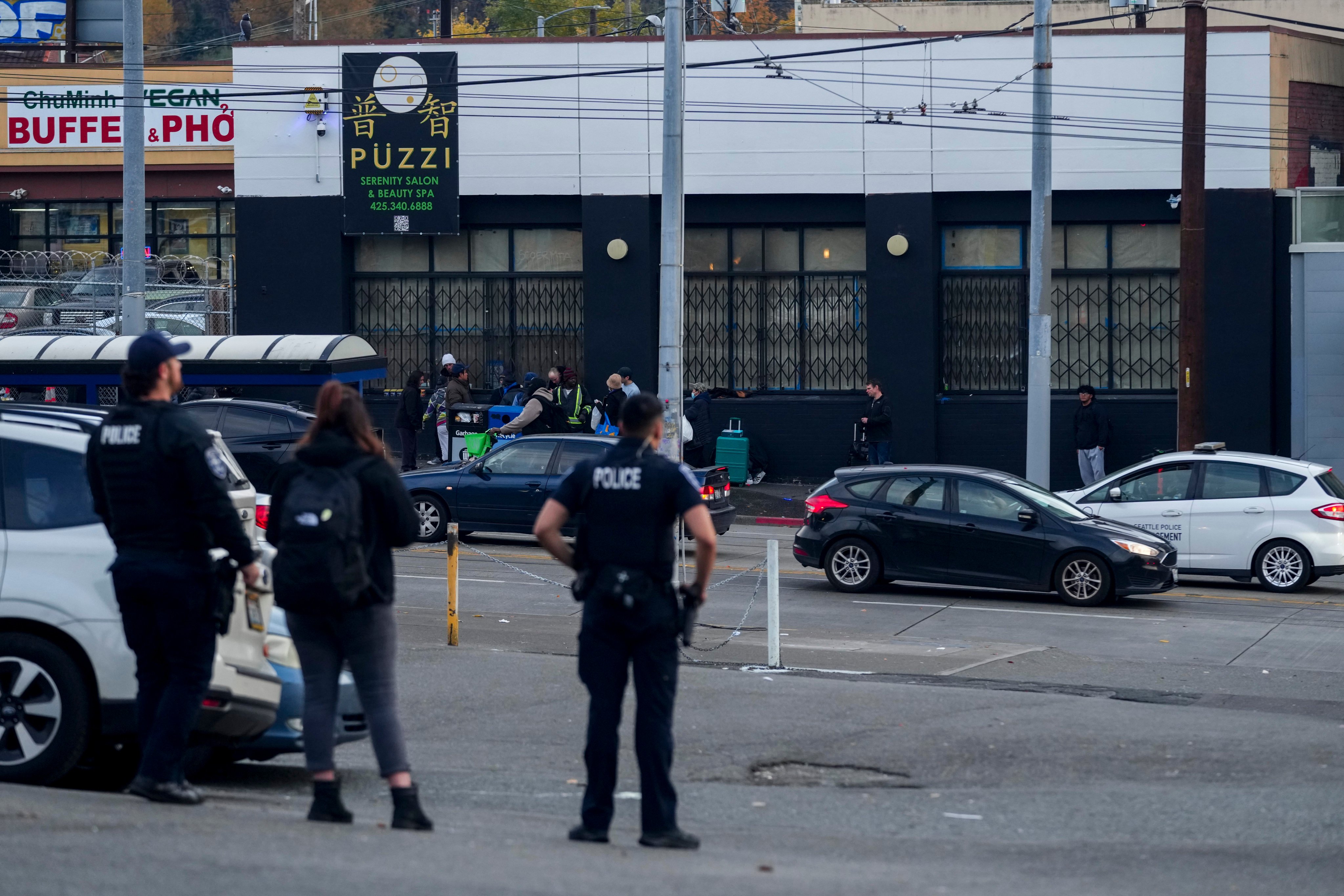 Police officers stand near the scene where multiple people were stabbed in Seattle’s Chinatown-International District on November 8. Photo: AP