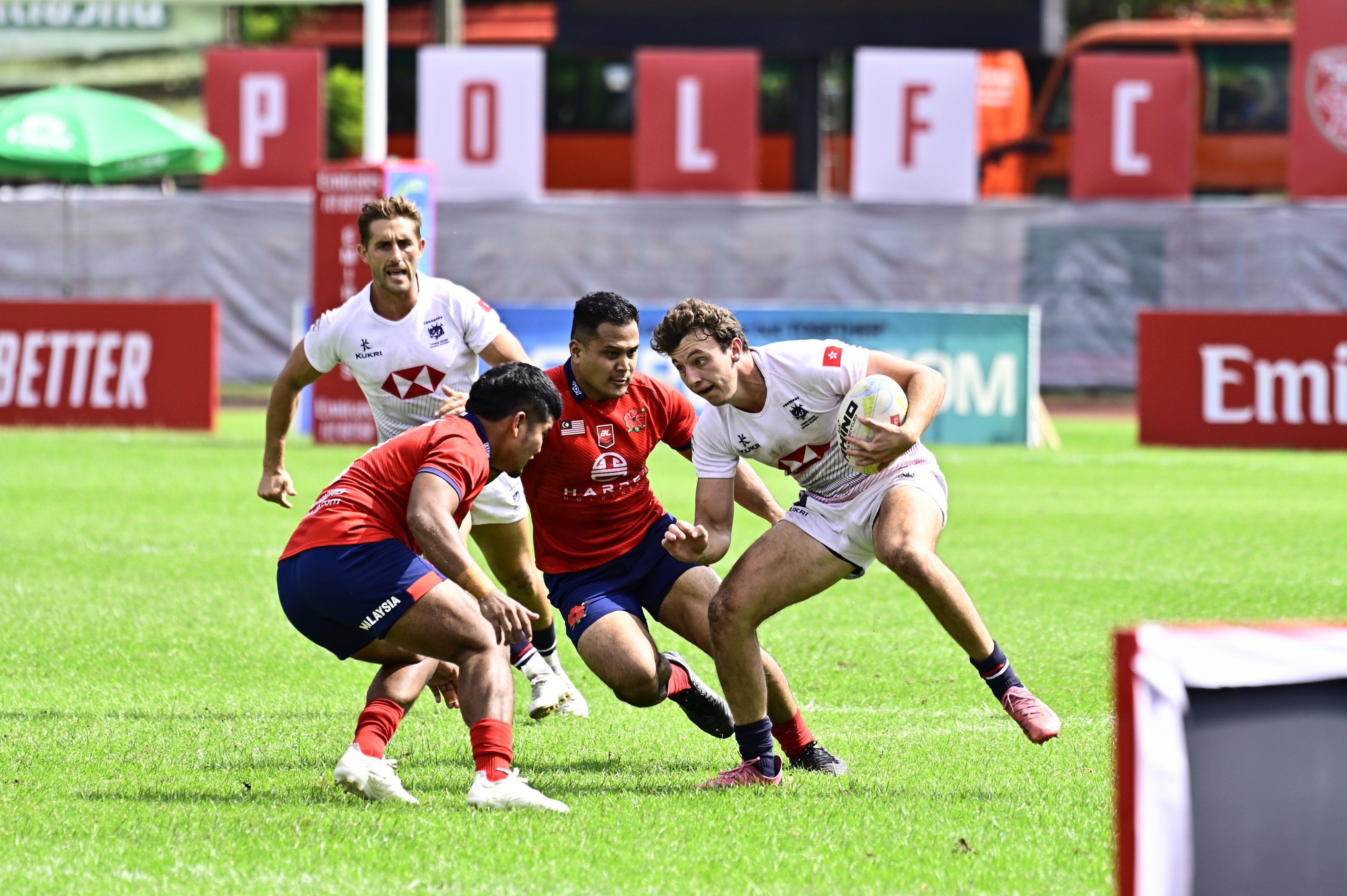 Liam Doherty evades two tacklers during Hong Kong’s crushing victory over Malaysia. Photo: HKCR