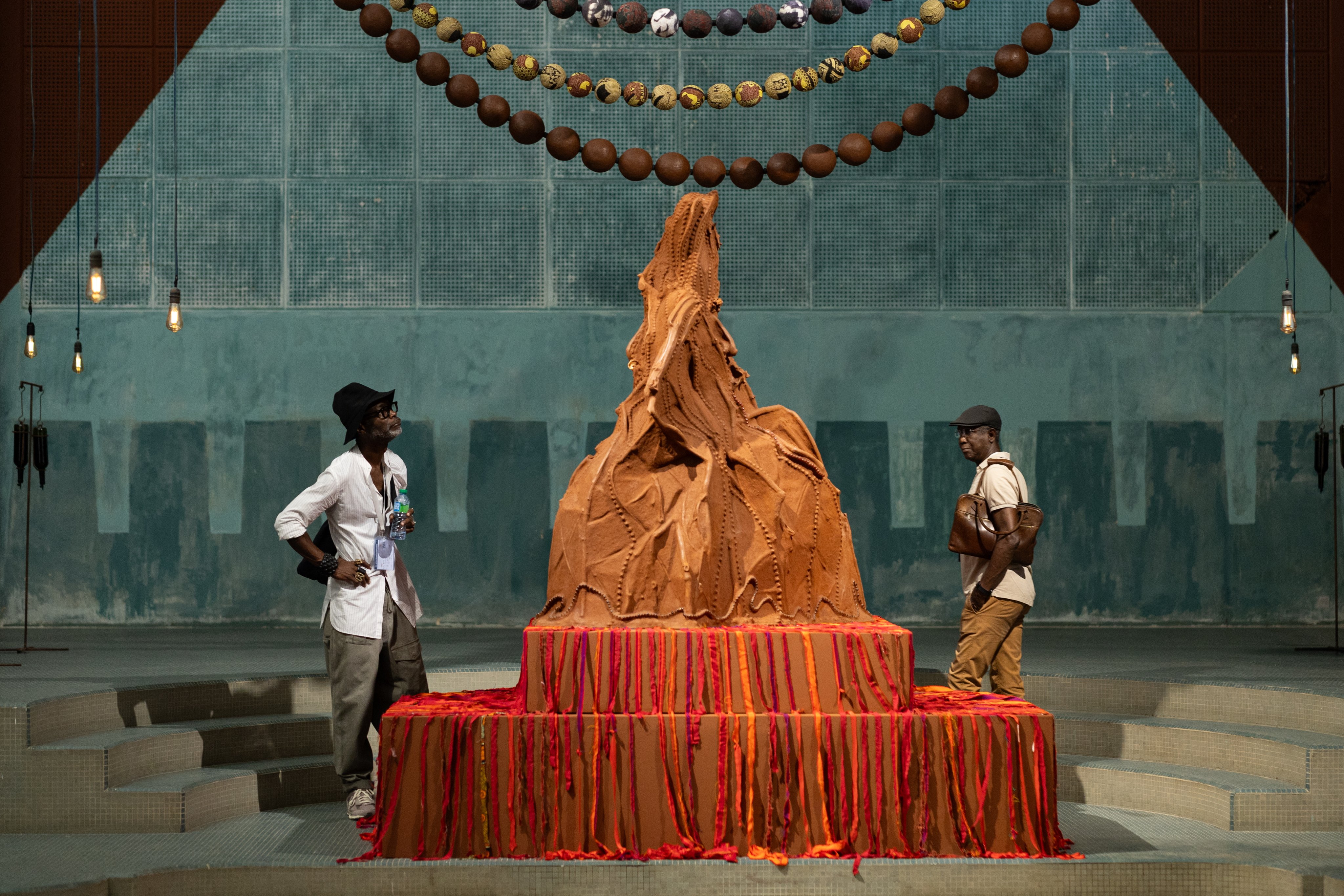 Visitors to the 15th Biennale of Contemporary African Art in Dakar, Senegal, view part of an installation called A Palace in Pieces including Mountain Mama by Kenyan artist Wangechi Mutu. The exhibition’s theme is “The Wake”. Photo: EPA-EFE