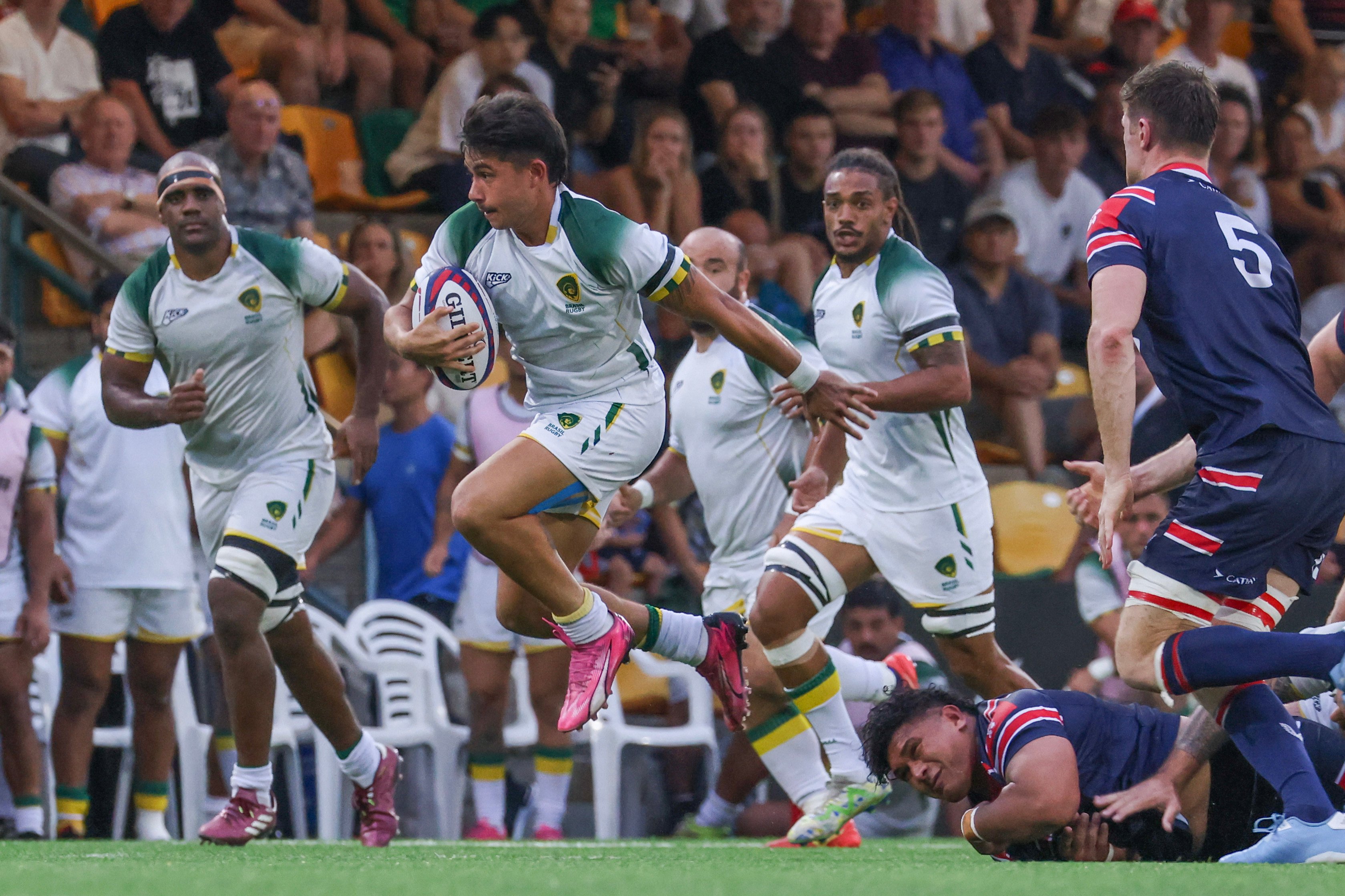 Brazil’s Joao Amaral runs out of a tackle by Hong Kong’s Sunia Fameitau during the first Test at Football Club. Photo: Nora Tam