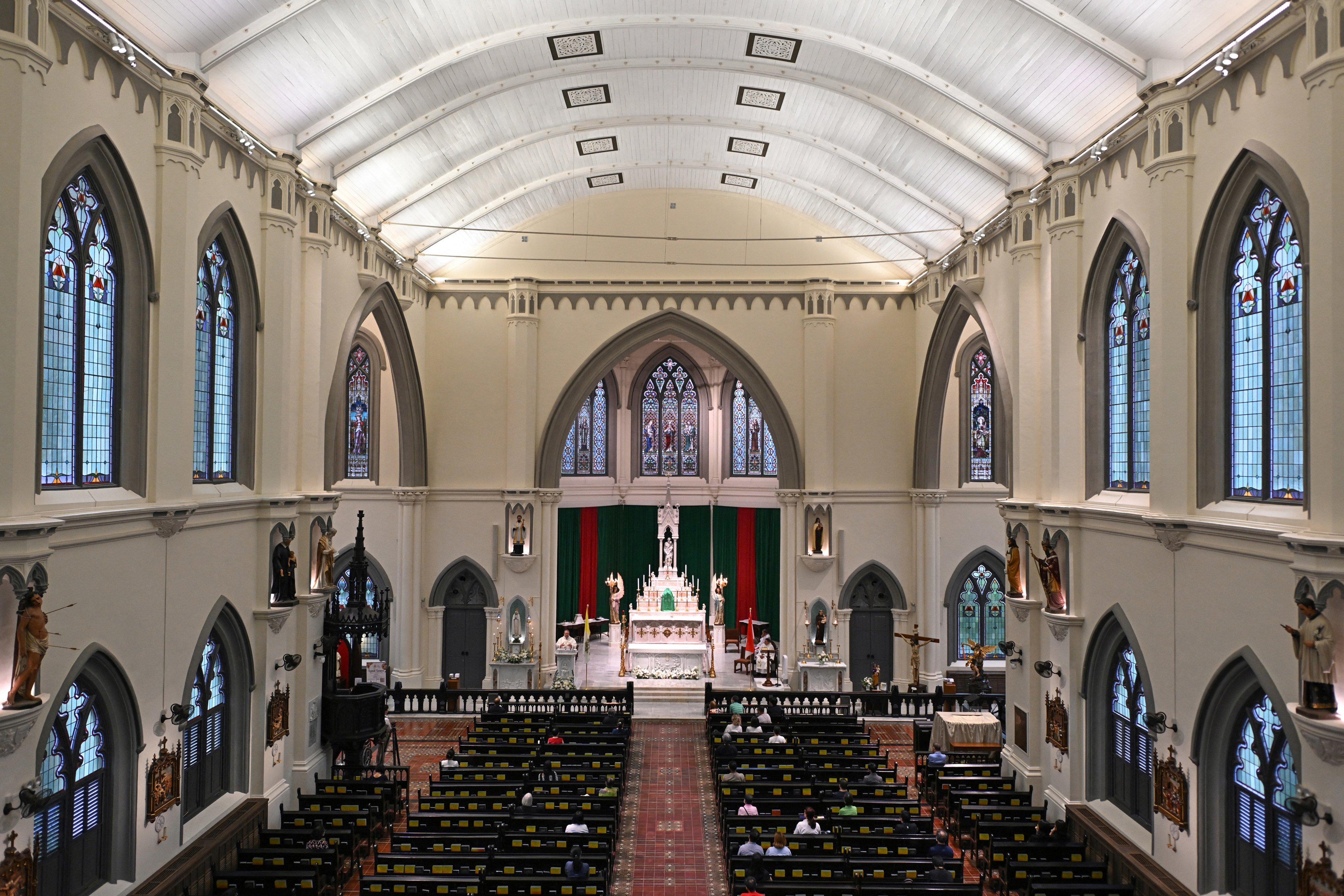 Catholics attend a mass at St. Joseph’s Church in Singapore earlier this year. Photo: AFP