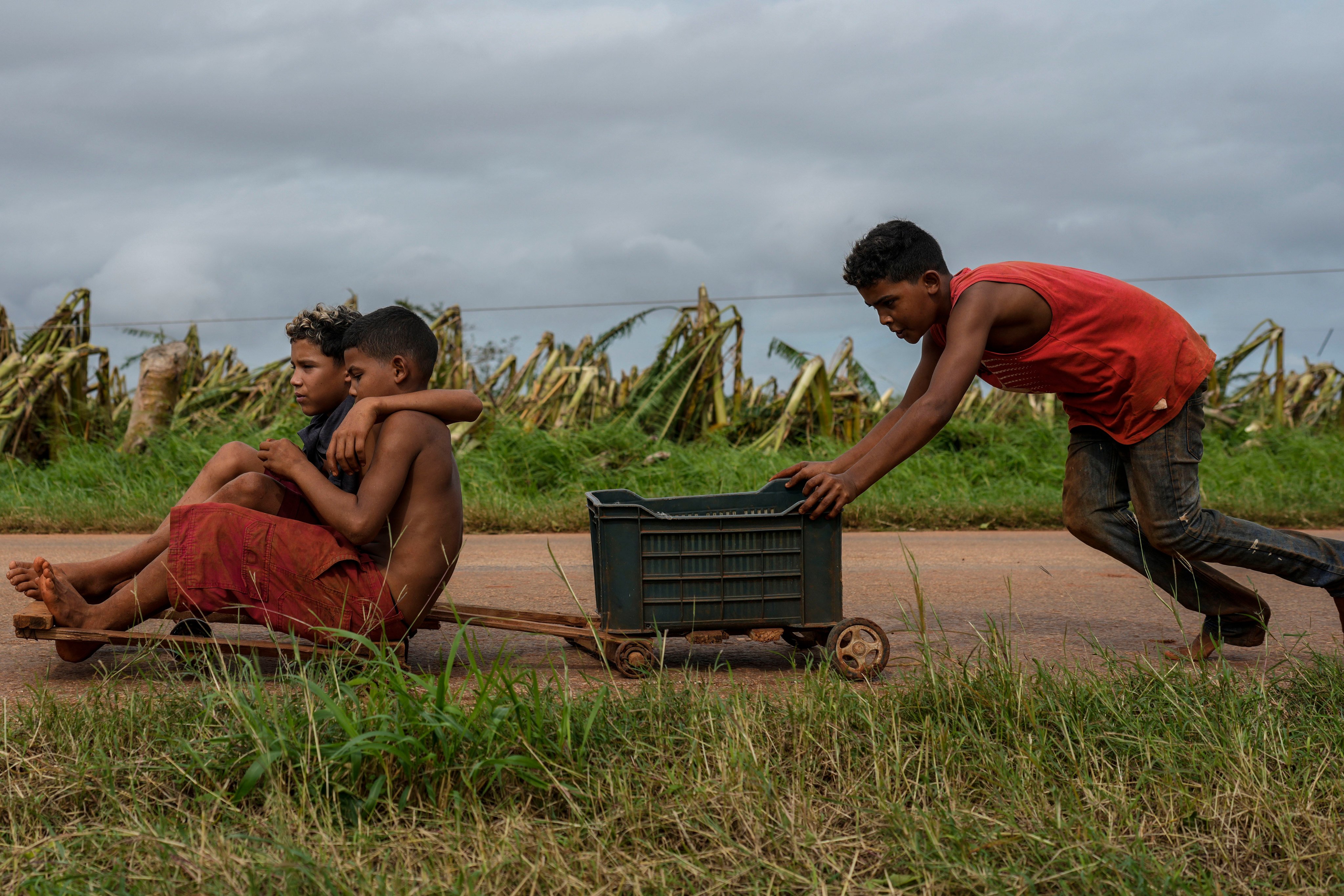 Cuban children play on a road after Hurricane Rafael last week. Photo: AP