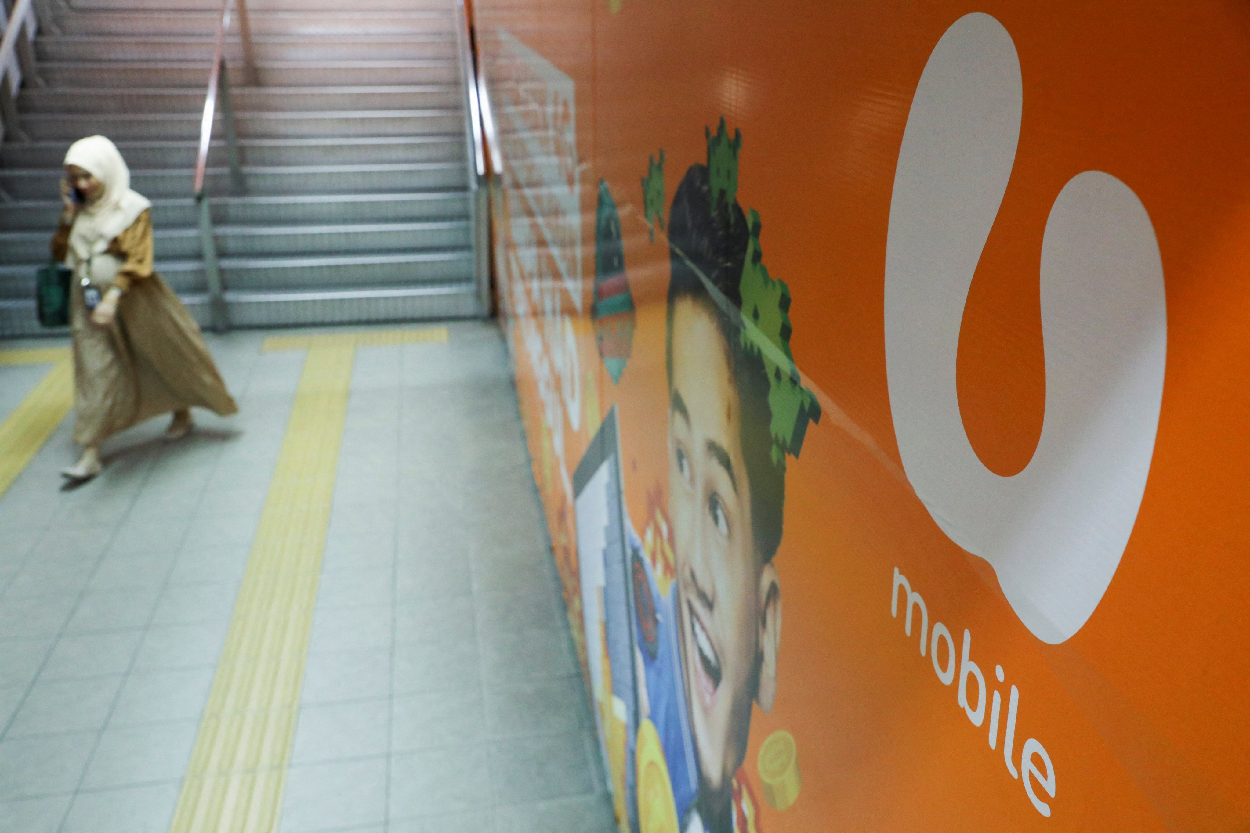 The logo of U Mobile is displayed at a monorail station in Kuala Lumpur, Malaysia. Photo: Reuters