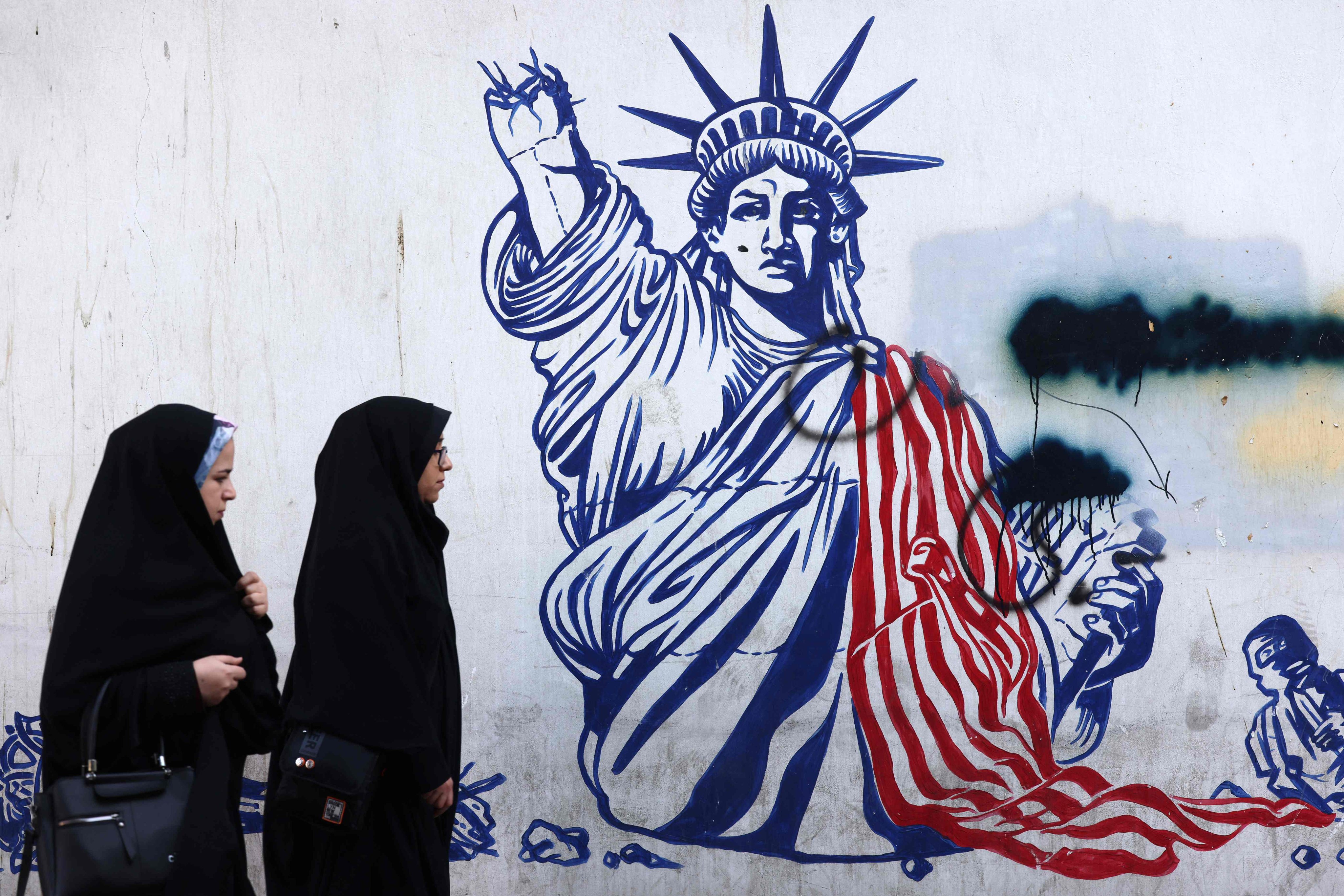 A mural depicting the Statue of Liberty with the torch-bearing arm broken, in Tehran. Photo: AFP