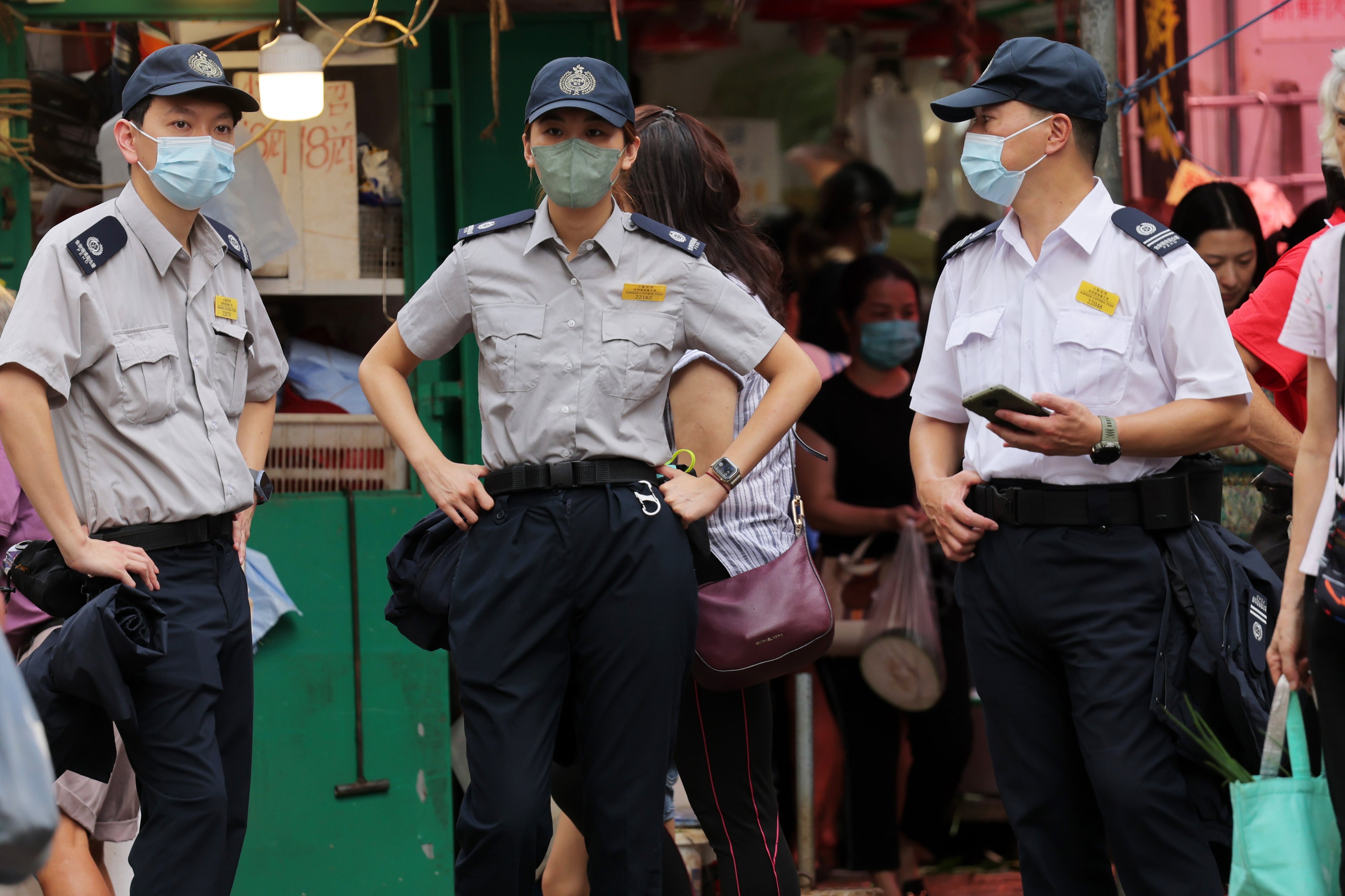 Officers from the Food and Environmental Hygiene Department patrol a street in Mong Kok. Photo: Jelly Tse