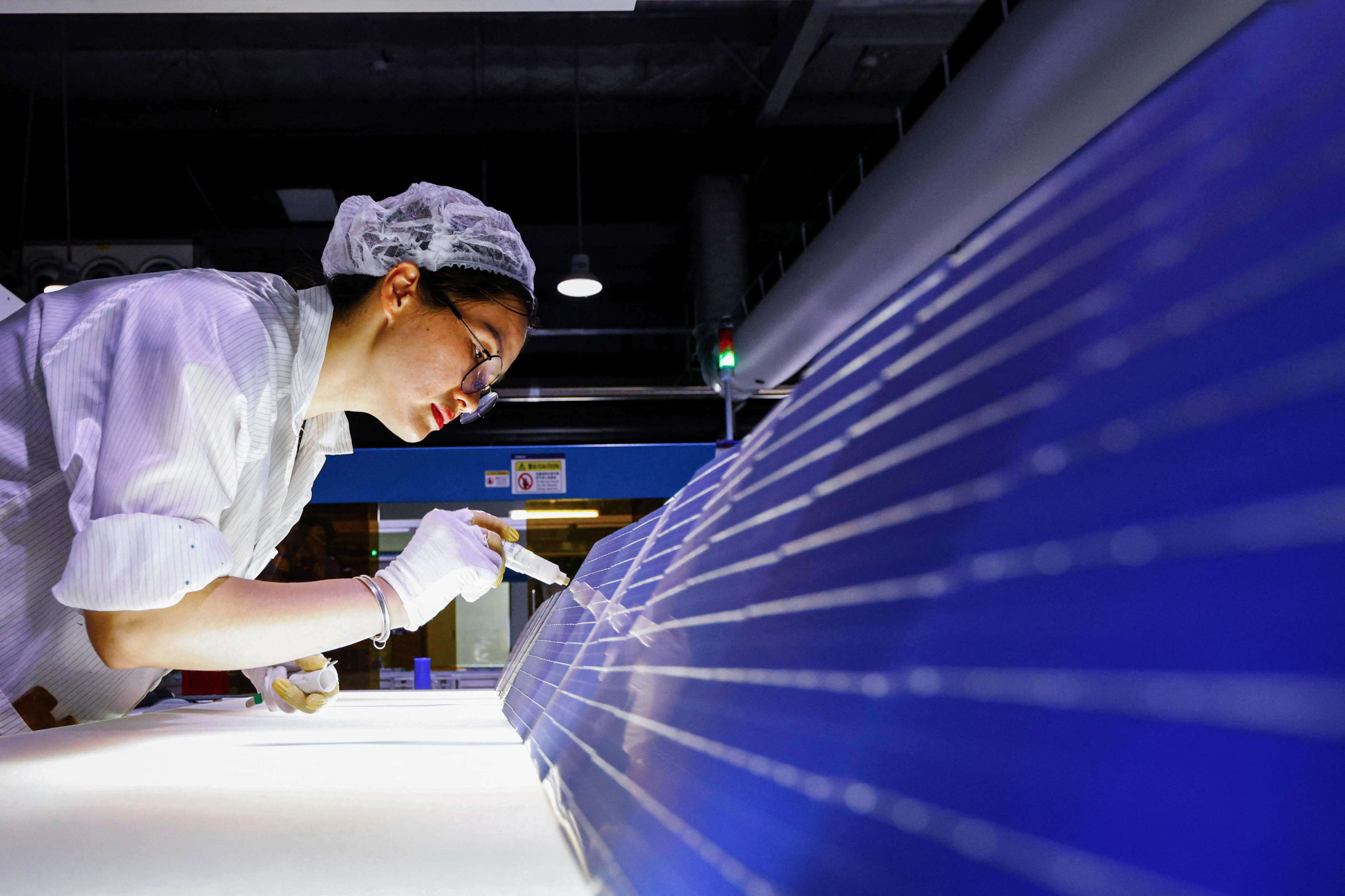 An employee works on solar photovoltaic modules for export at a factory in Sihong in eastern China’s Jiangsu province in September 2024. Photo: AFP