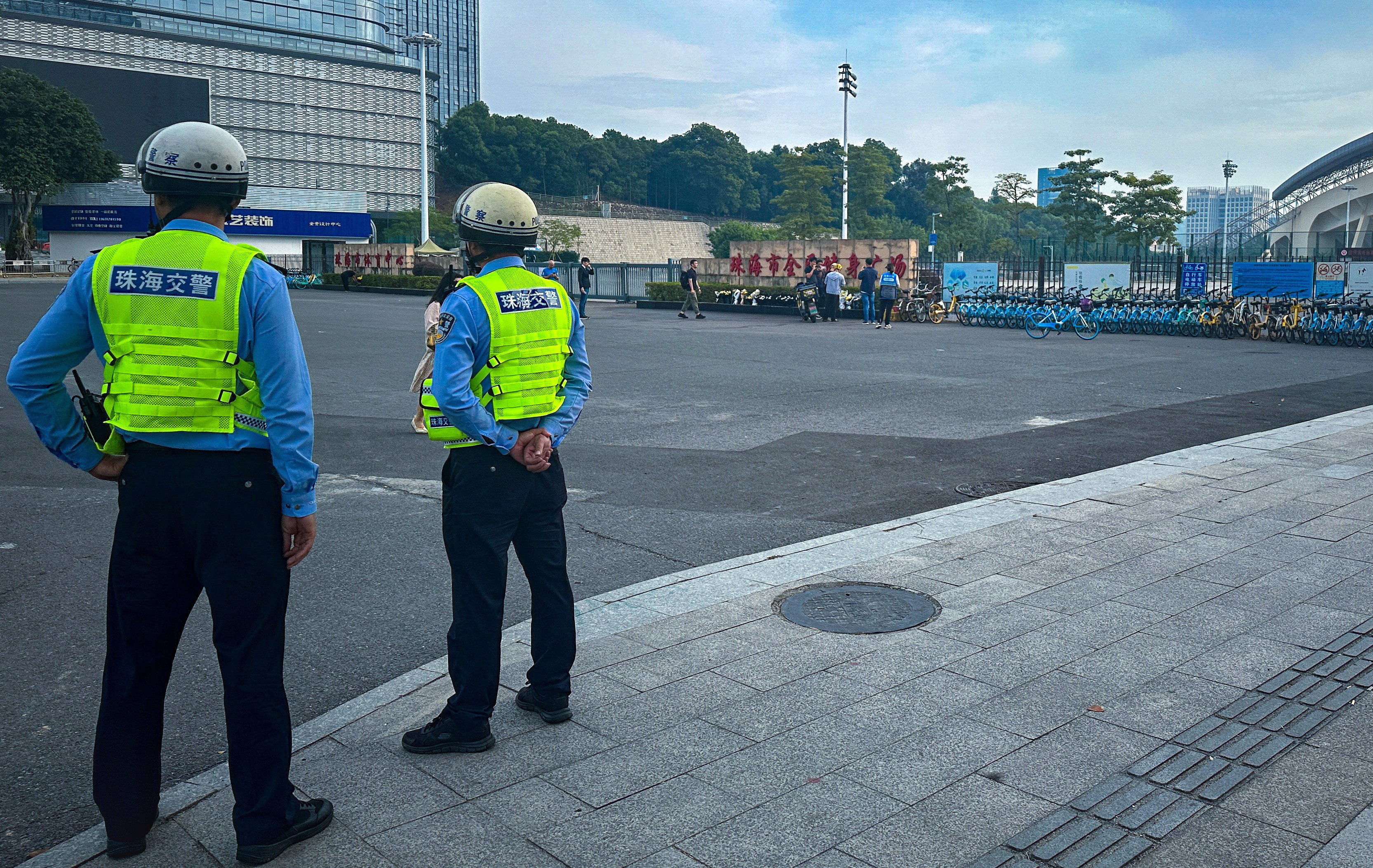 Police officers stand outside the stadium where a deadly car attack took place in Zhuhai, Guangdong province. Photo: Reuters