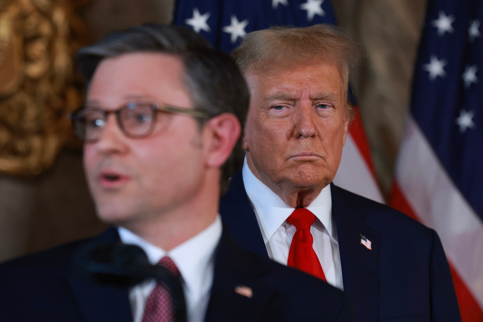 Donald Trump listens as US Speaker of the House Mike Johnson speaks during a press conference at Mar-a-Lago in April. Photo: TNS