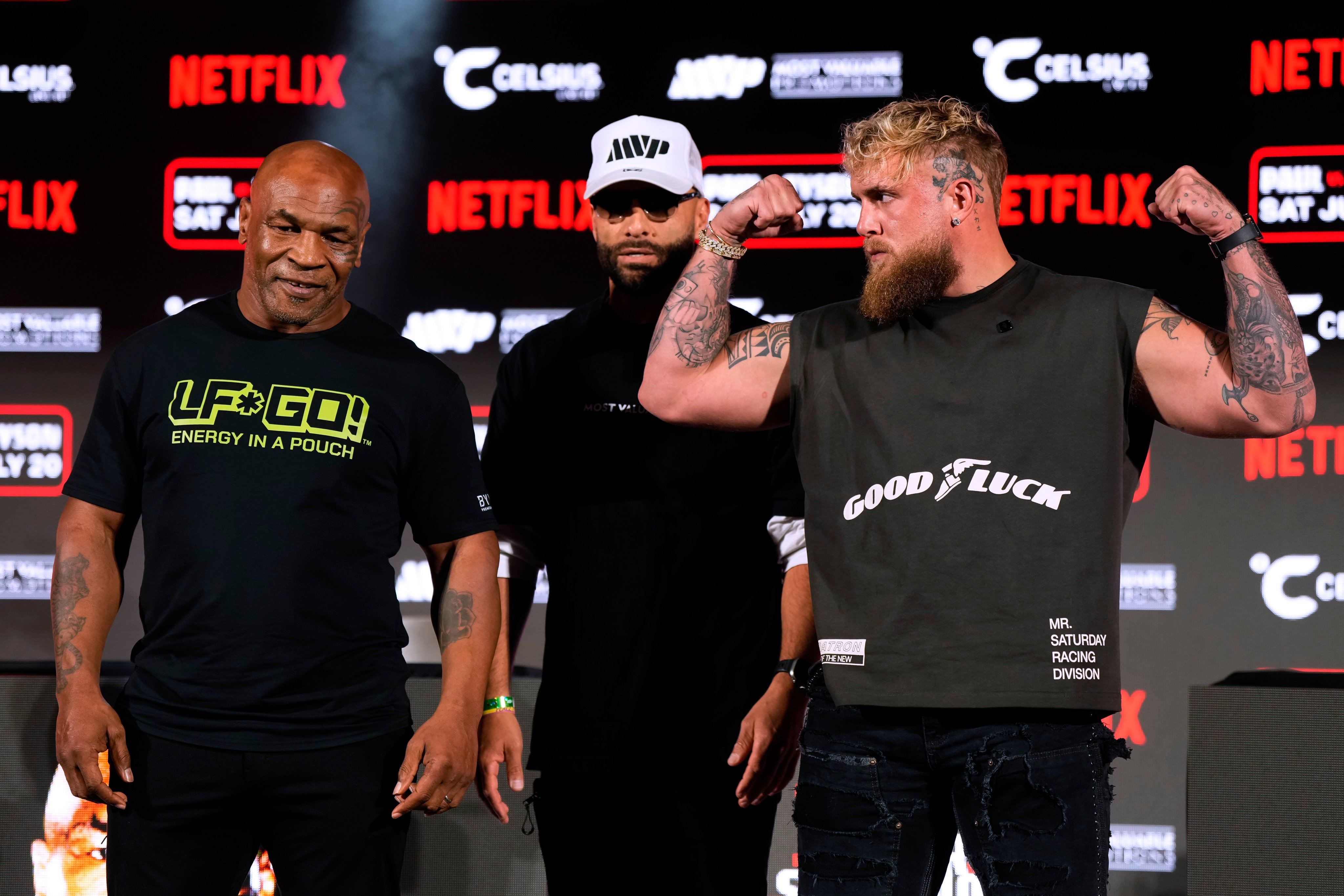 Mike Tyson, left, and Jake Paul, right, pose for photos during a news conference promoting their coming boxing bout. Photo: AP