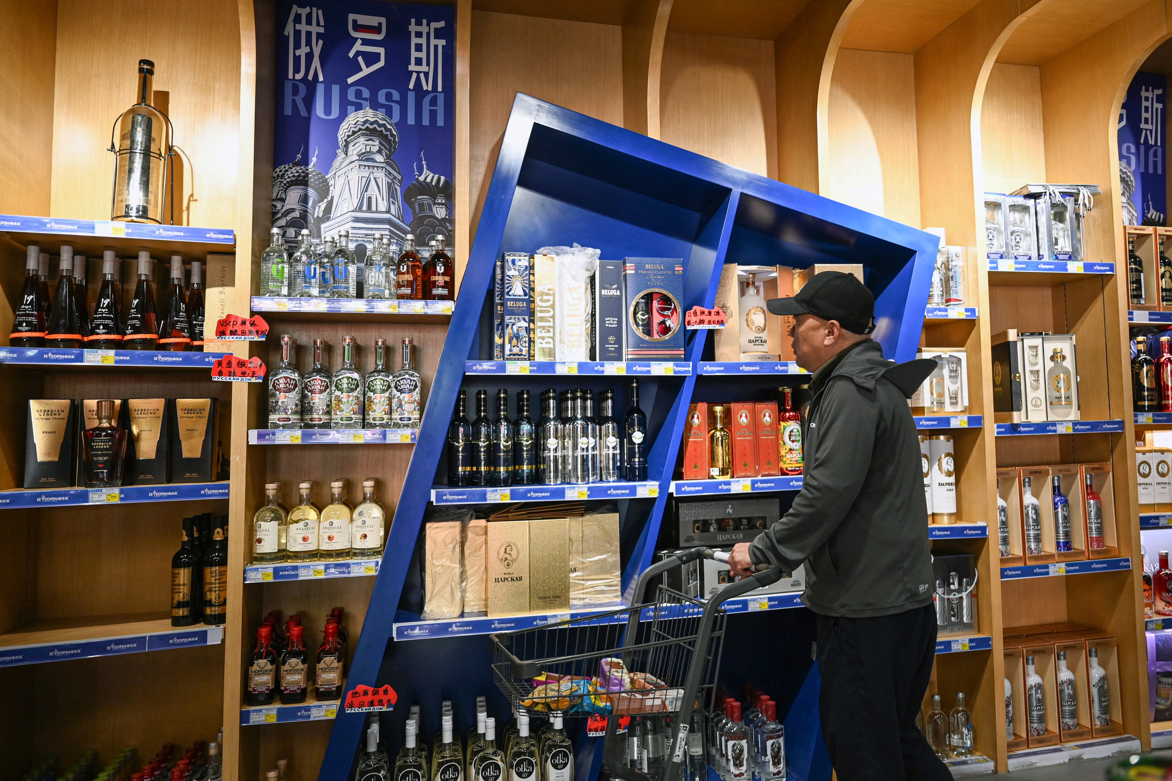 A man browses through alcohol at a market where Russian products are sold in Beijing. Photo: AFP