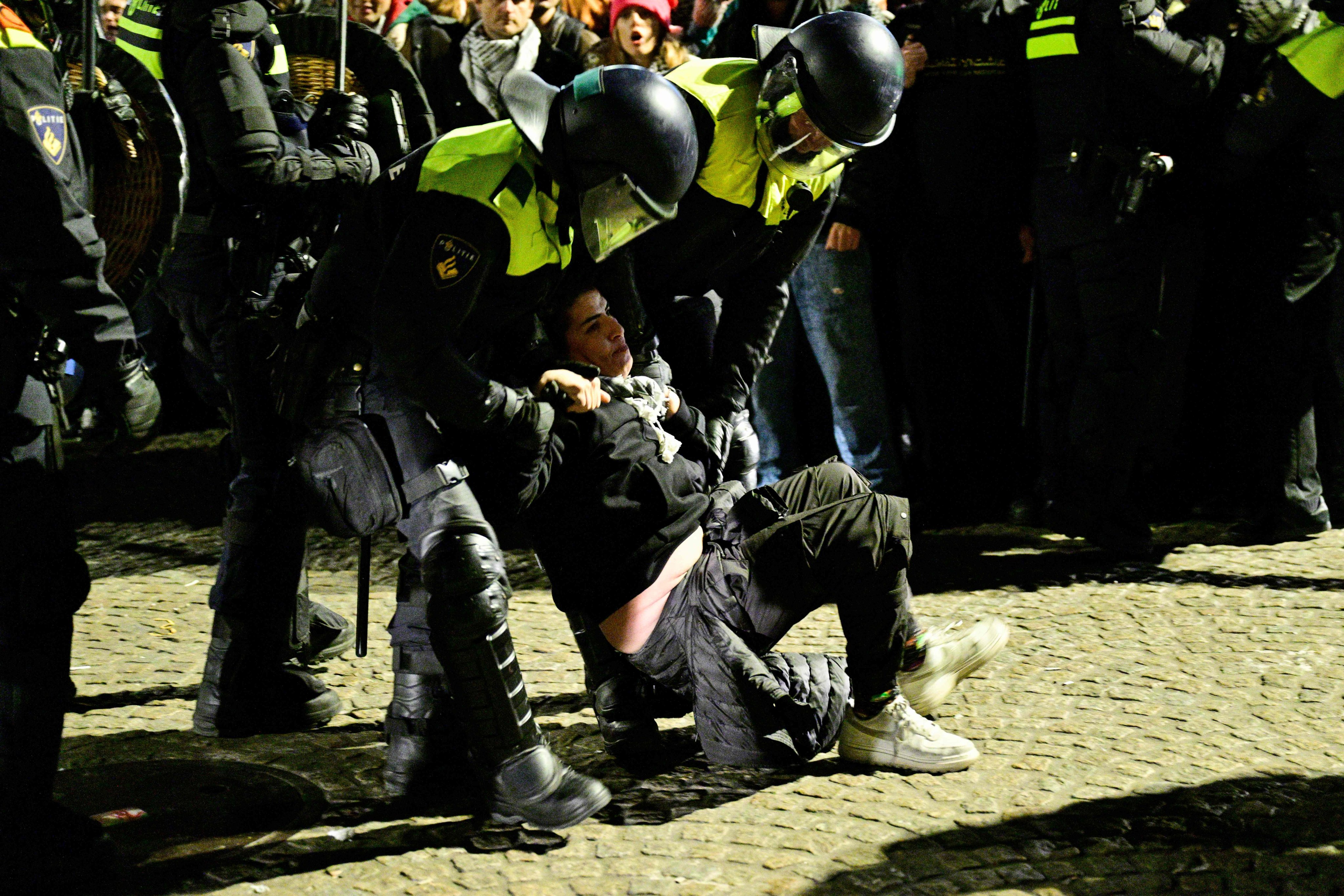 Police officers detain a protestor at a protest on Dam Square in Amsterdam. Photo: AFP