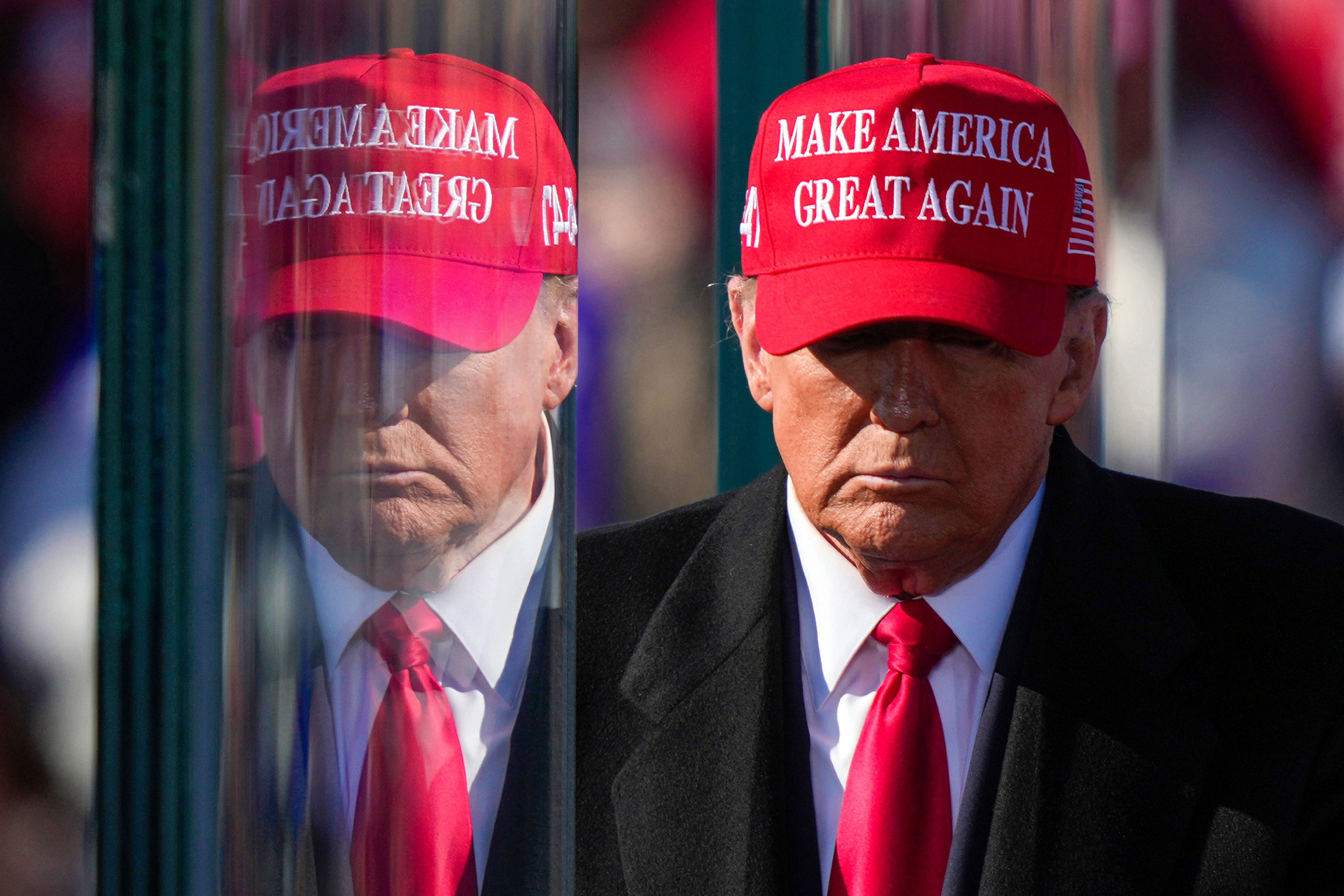 Donald Trump is reflected in the bullet-proof glass as he finishes speaking at a campaign rally in Lititz, Pennsylvania, on November 3. Photo: AP