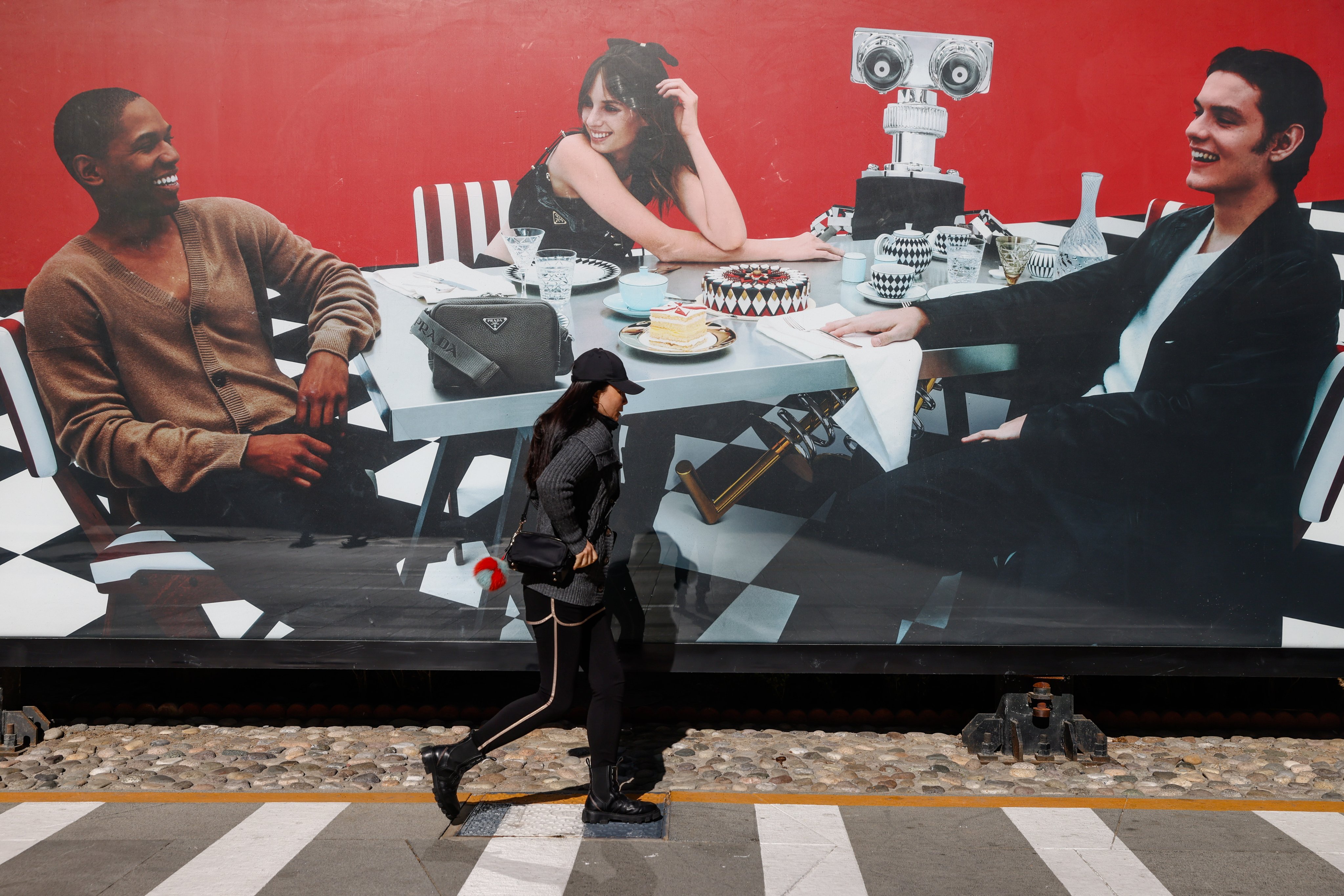 A woman walks beside a shopping mall in the central business district in Beijing. Photo: EPA-EFE