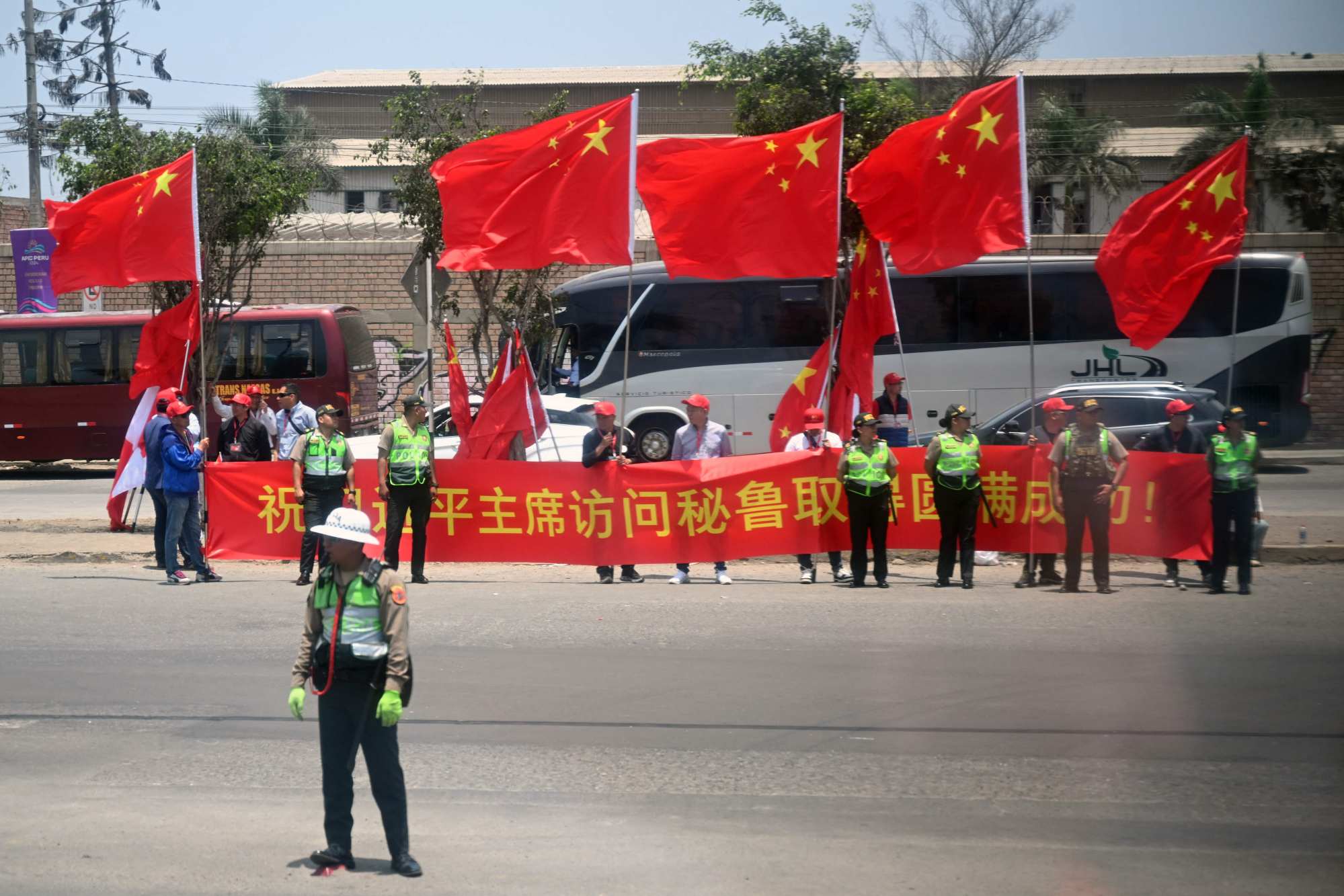 Chinese citizens in Peru wait for Xi Jinping’s arrival at Jorge Chavez International Airport in Callao, outside Lima, on Thursday. Photo: AFP