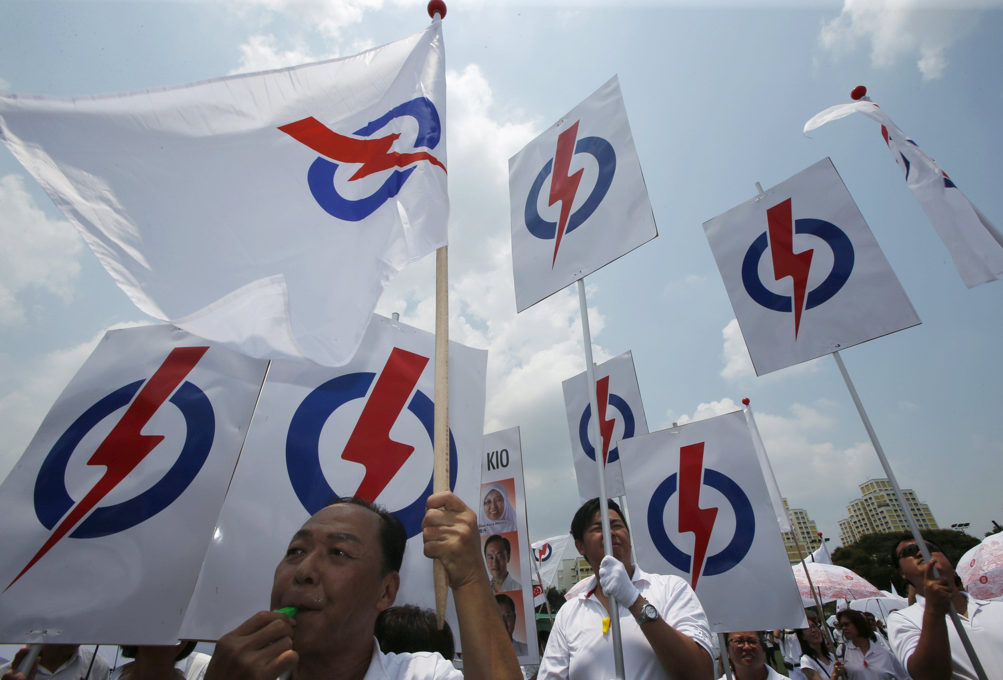 Supporters of Singapore’s ruling People’s Action Party (PAP) wave party flags and placards ahead of the general election in 2015. Photo: Reuters