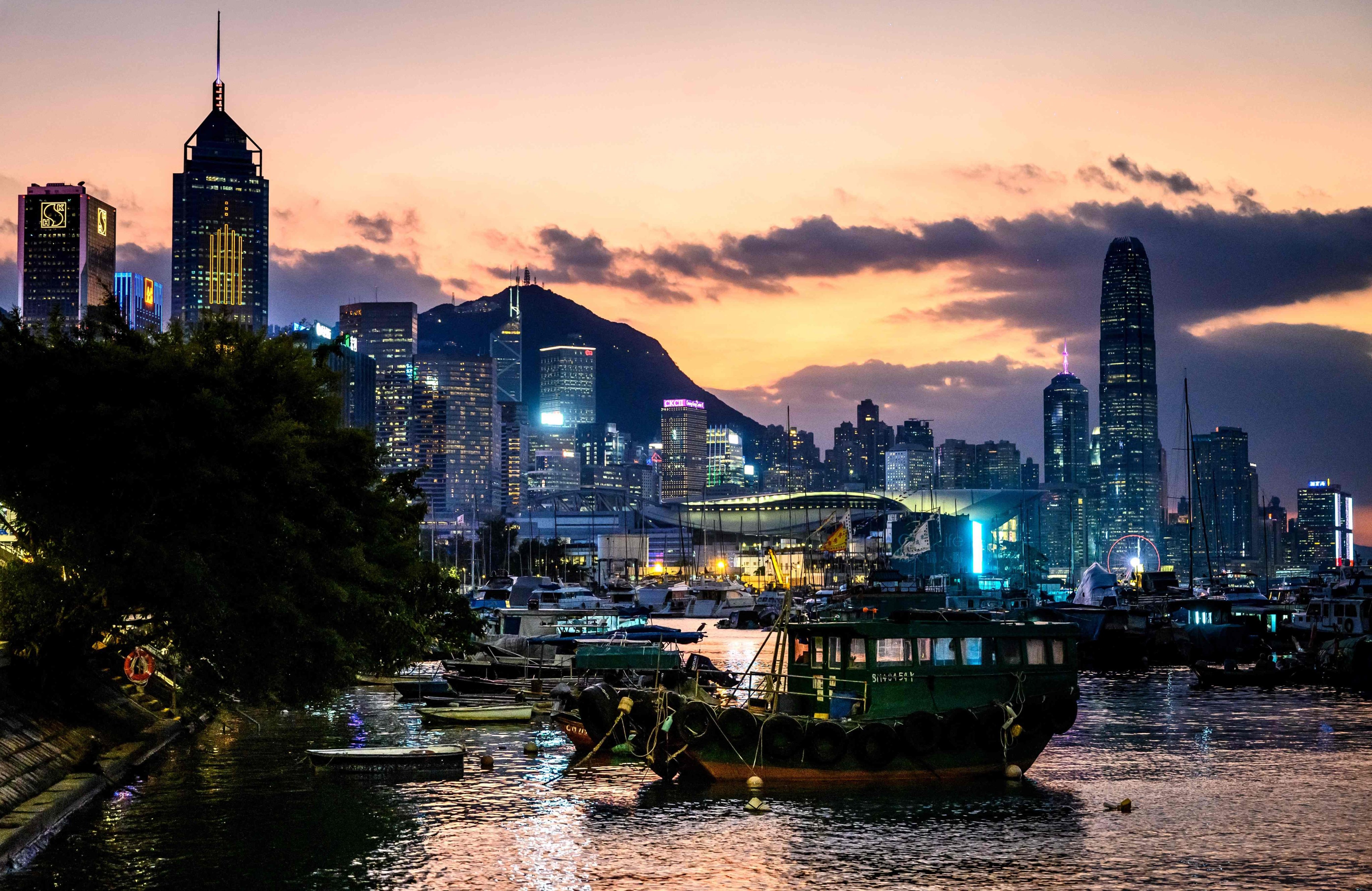 The sun sets behind Hong Kong’s skyline on November 1. Photo: AFP