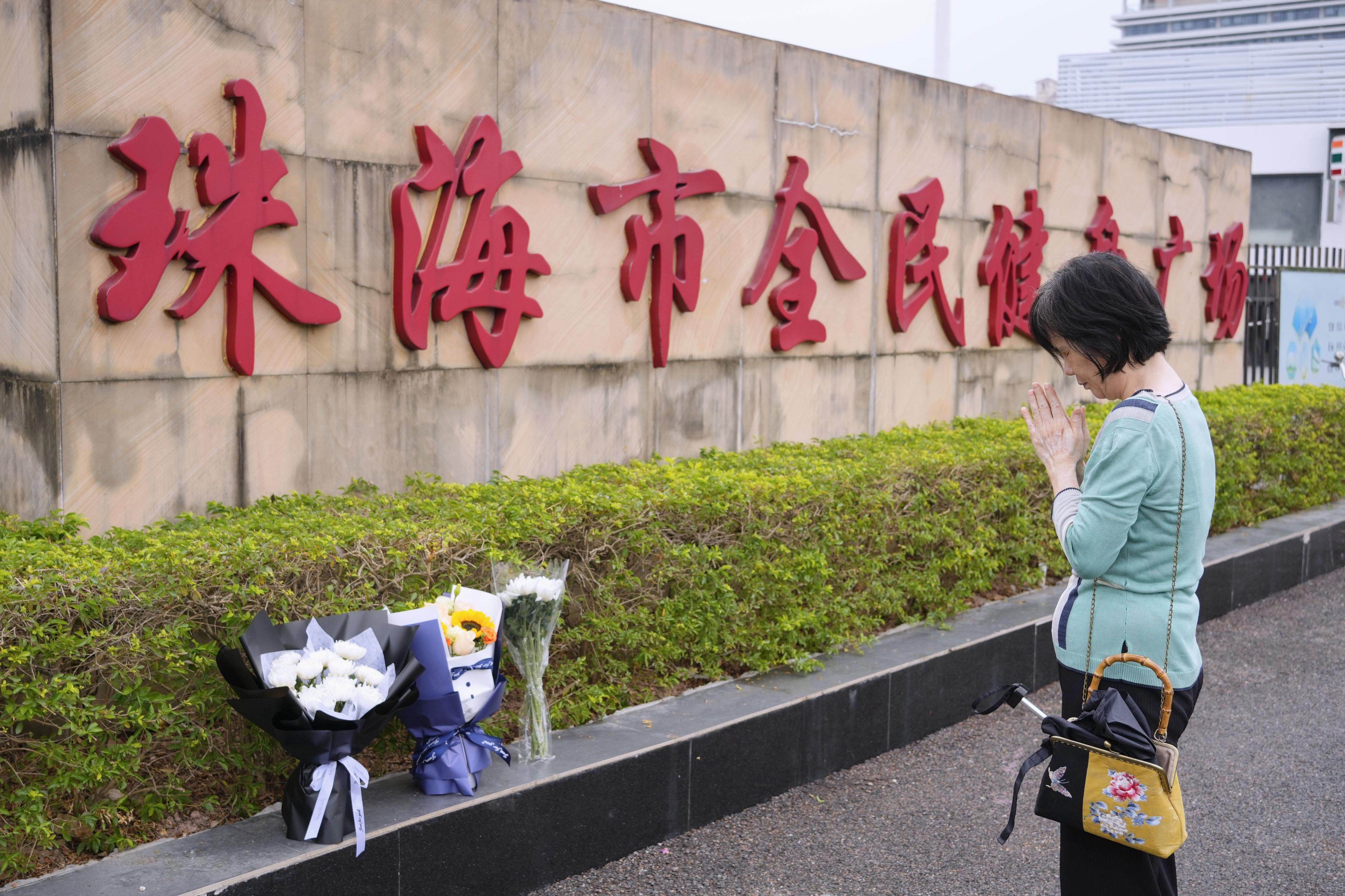 A mourner offers prayers on Wednesday outside a sports centre in Zhuhai, the site of Monday’s deadly attack. Photo: Kyodo