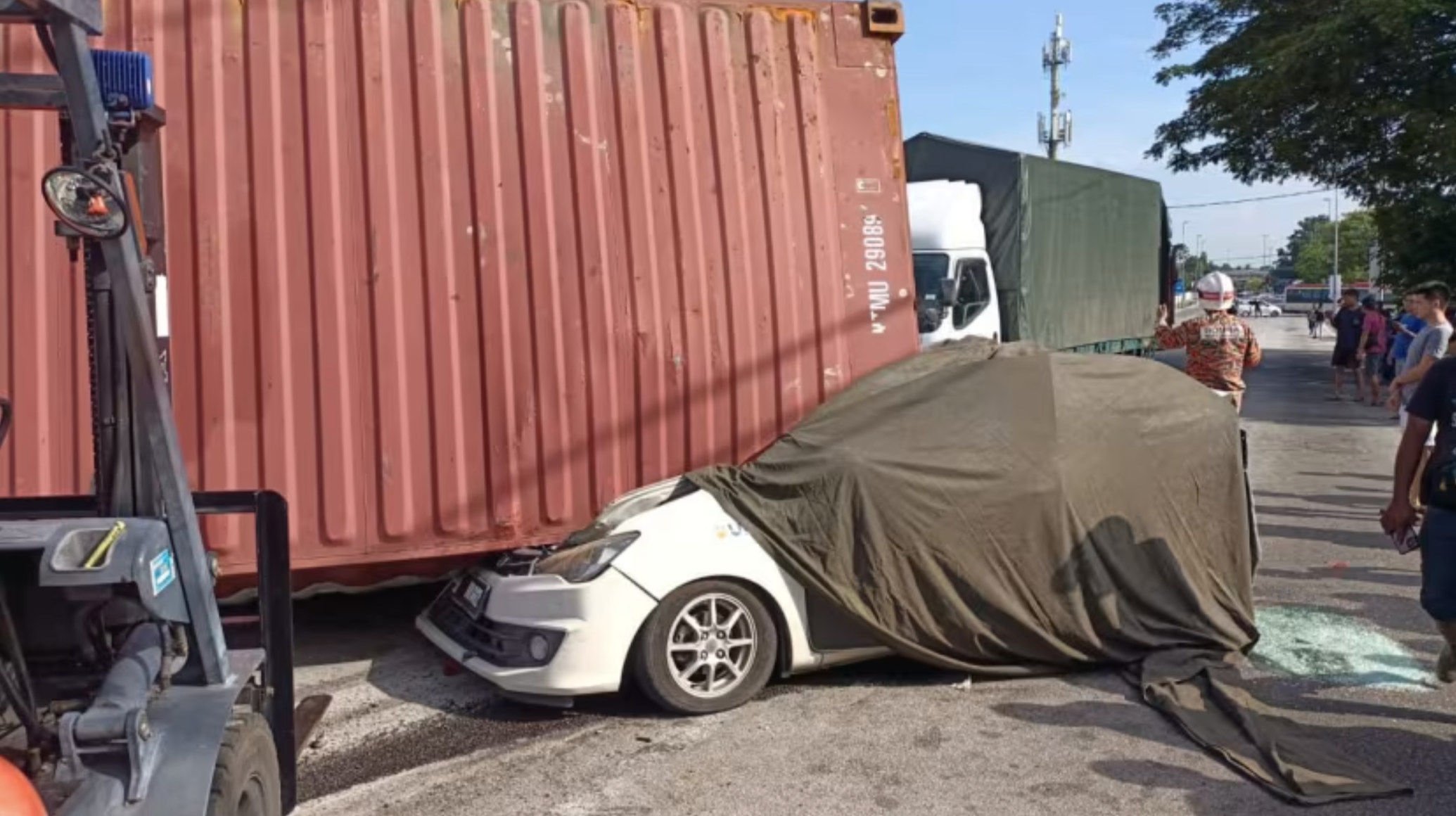 21-year-old Lee Zi Rou was killed when a container rolled off a semi-truck and fell onto her car.  Photo: Penang State Fire and Rescue Department