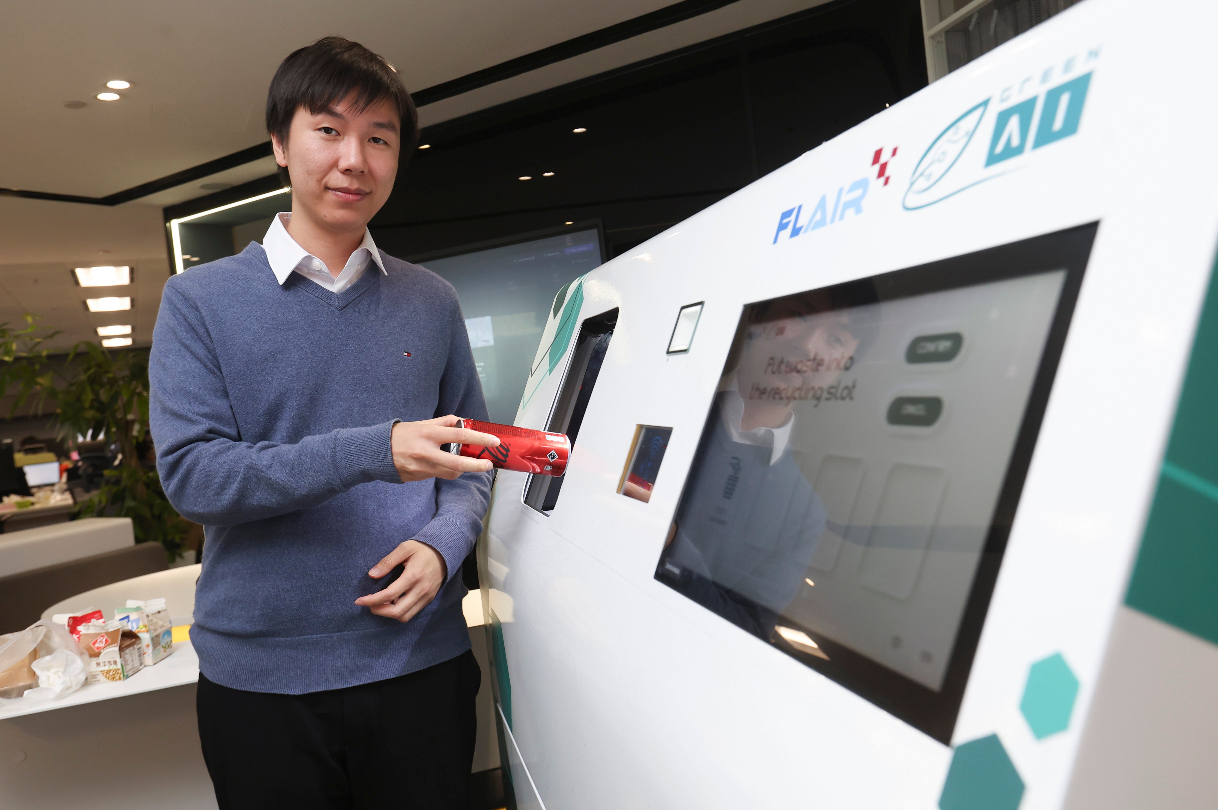 Cola Lam, CEO of Green Al Technology, gives a demonstration of the smart sorting bin at the company’s offices at Hong Kong Science Park in Sha Tin. Photo: Edmond So