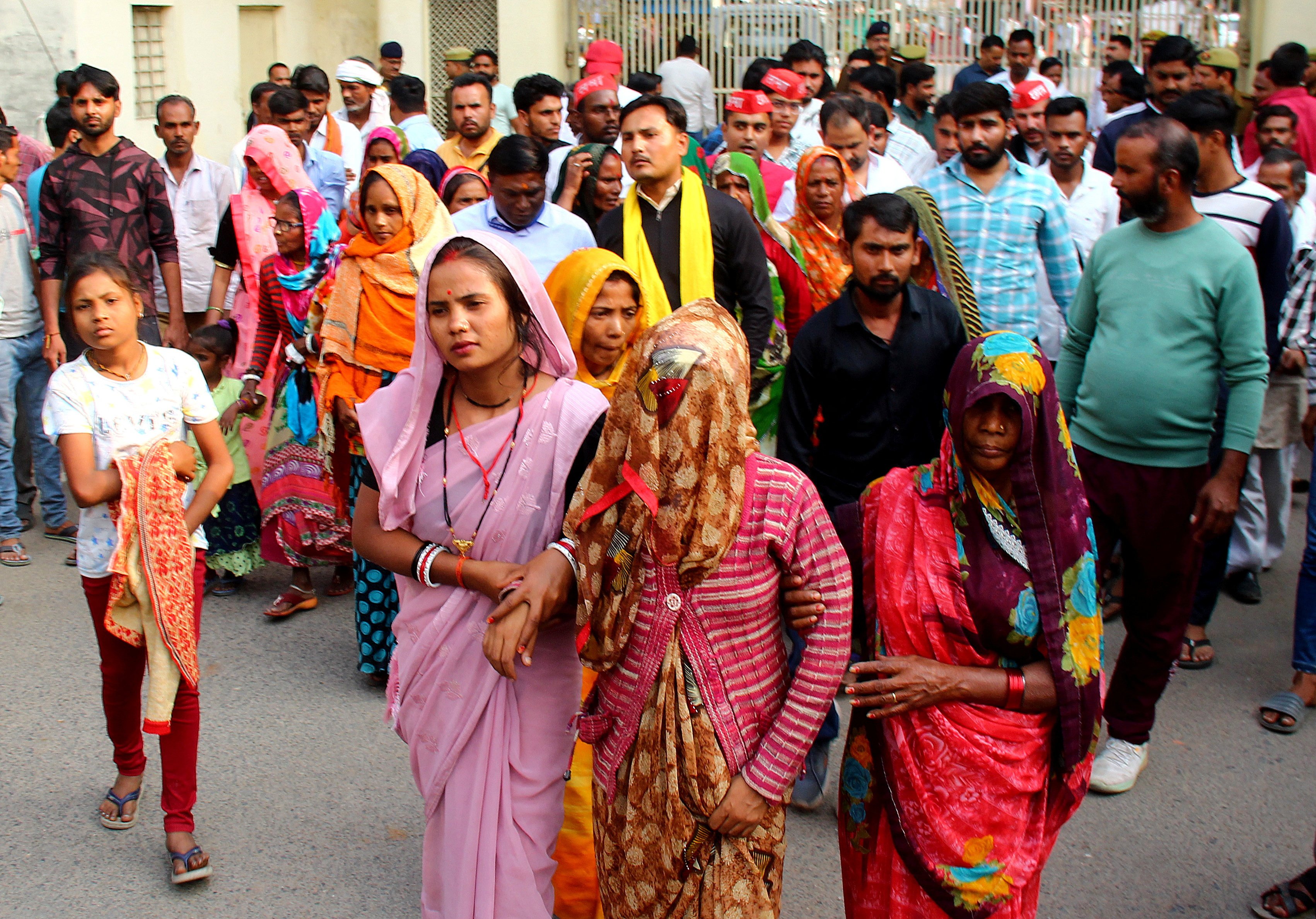 A mother of a newborn leaves with her relatives after she identified her son, who is being treated in a private hospital after he was rescued from the fire, on Saturday. Photo: Reuters