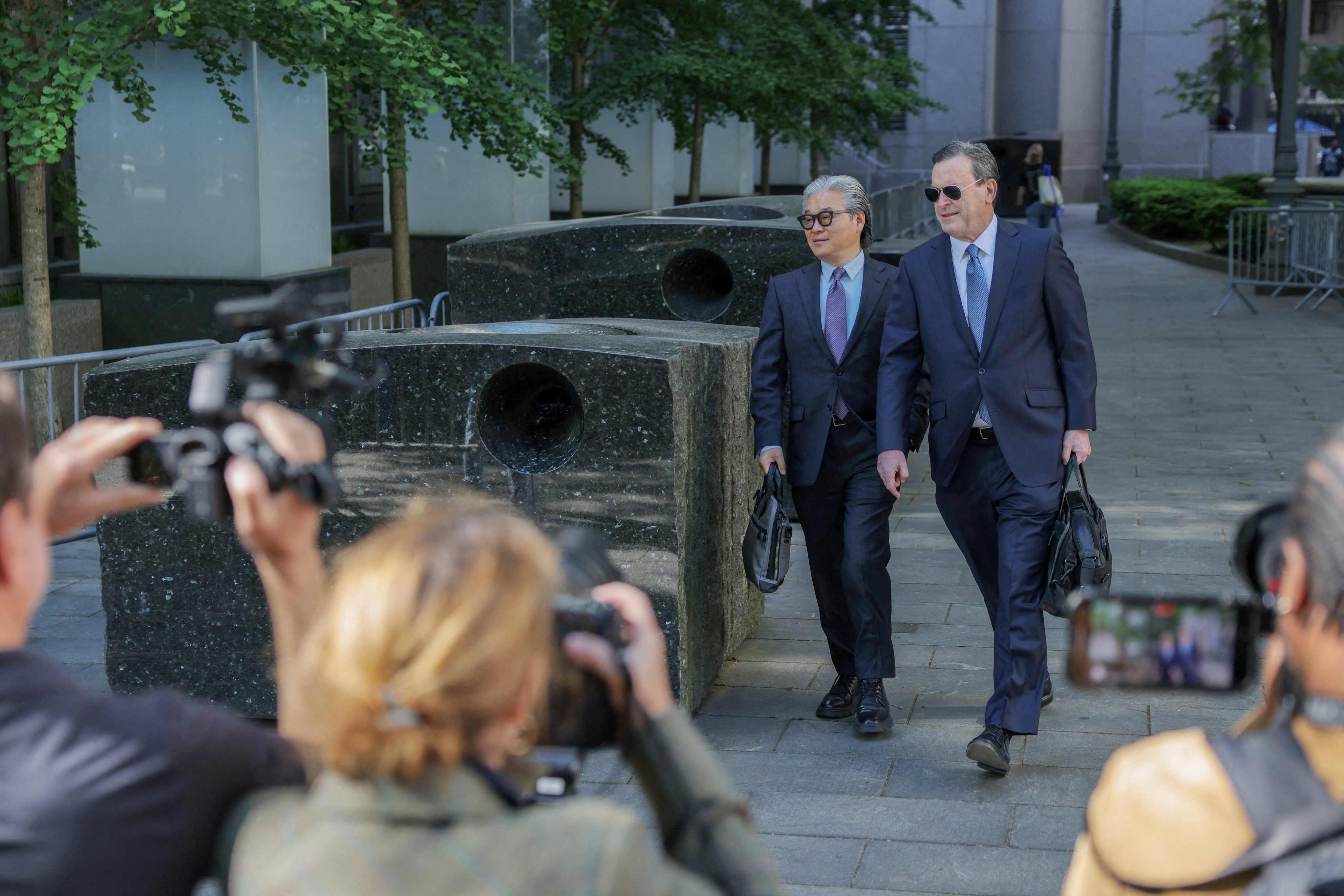 Bill Hwang (left) arrives for his trial at a New York City court in May. Photo: Reuters