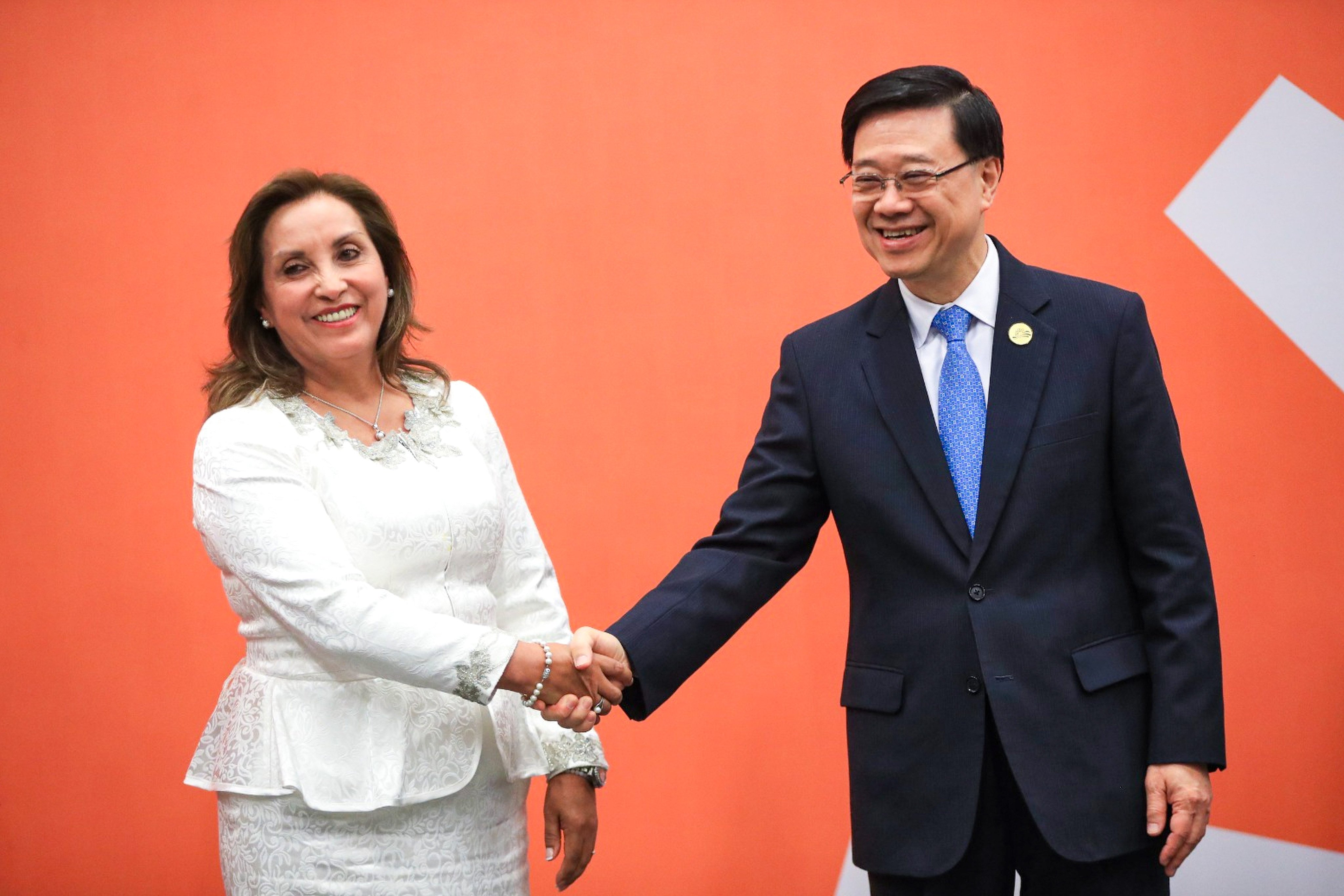 Peruvian President Dina Boluarte (left) and Hong Kong leader John Lee shake hands after their administrations signed a free-trade deal. Photo: Handout