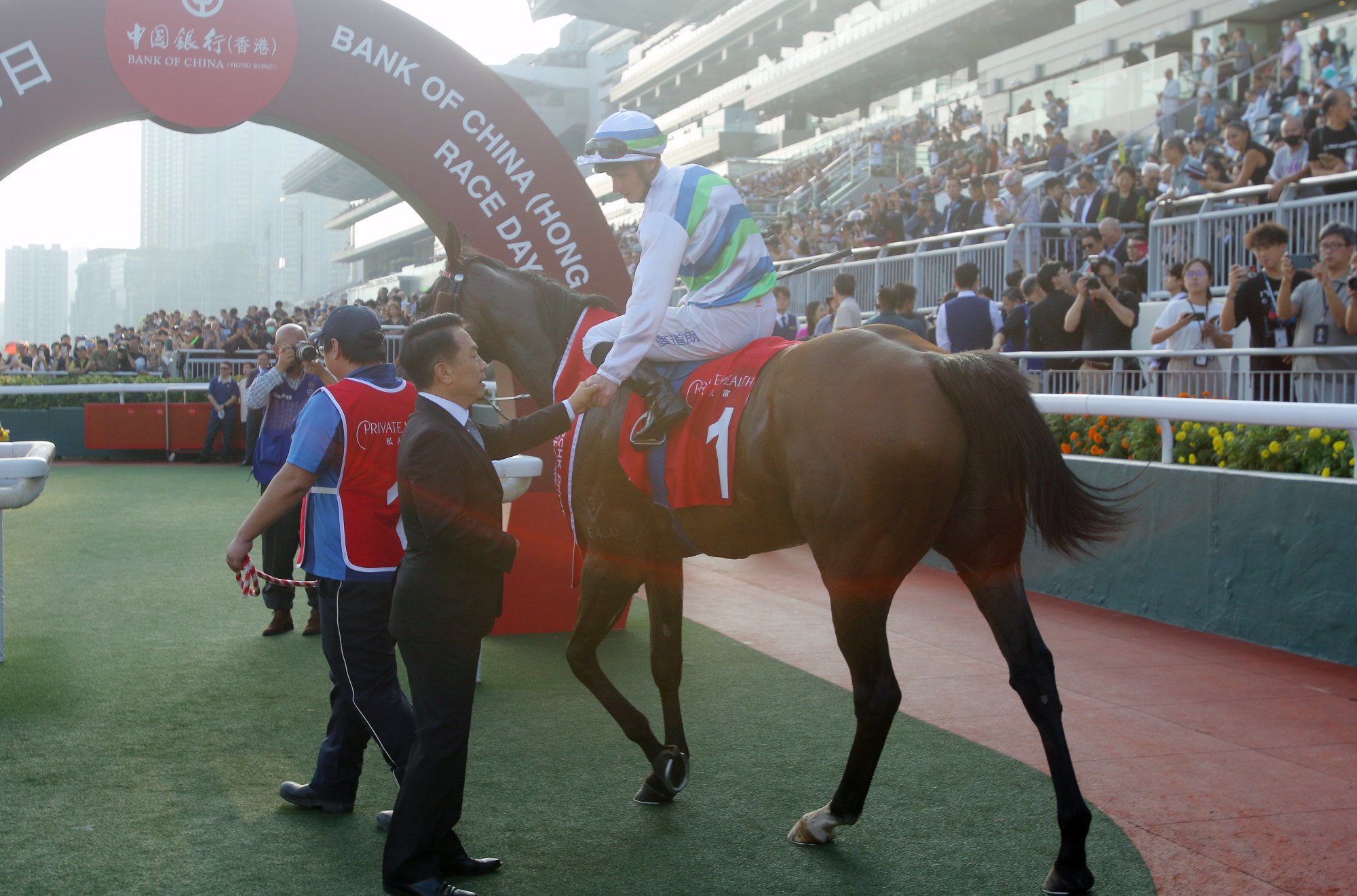 Trainer Ricky Yiu greets James McDonald in the winners’ enclosure.