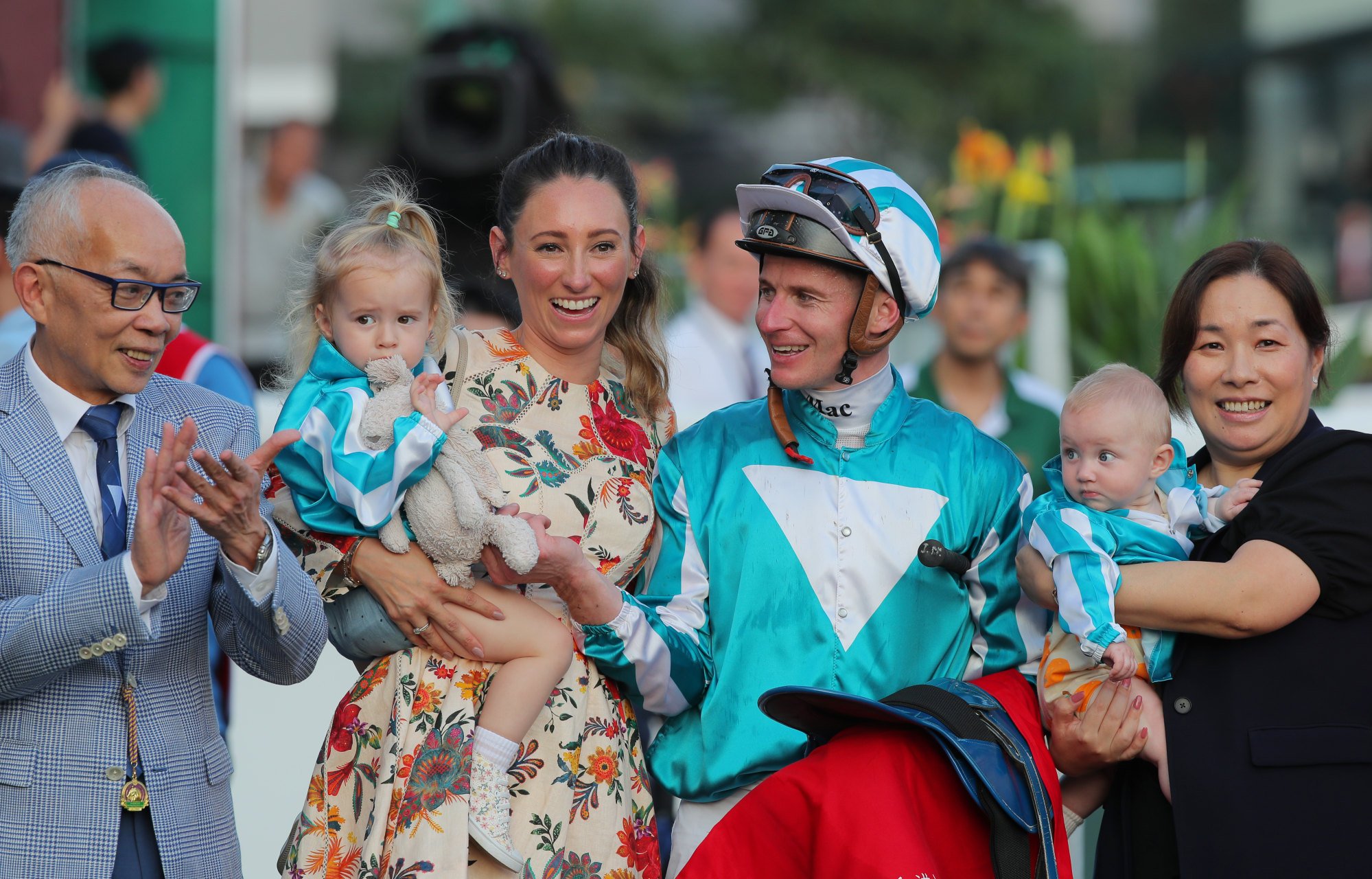 Jockey James McDonald celebrates with his wife Katelyn Mallyon (second from left), their daughters Evie Belle and Mia and owner Peter Lau.