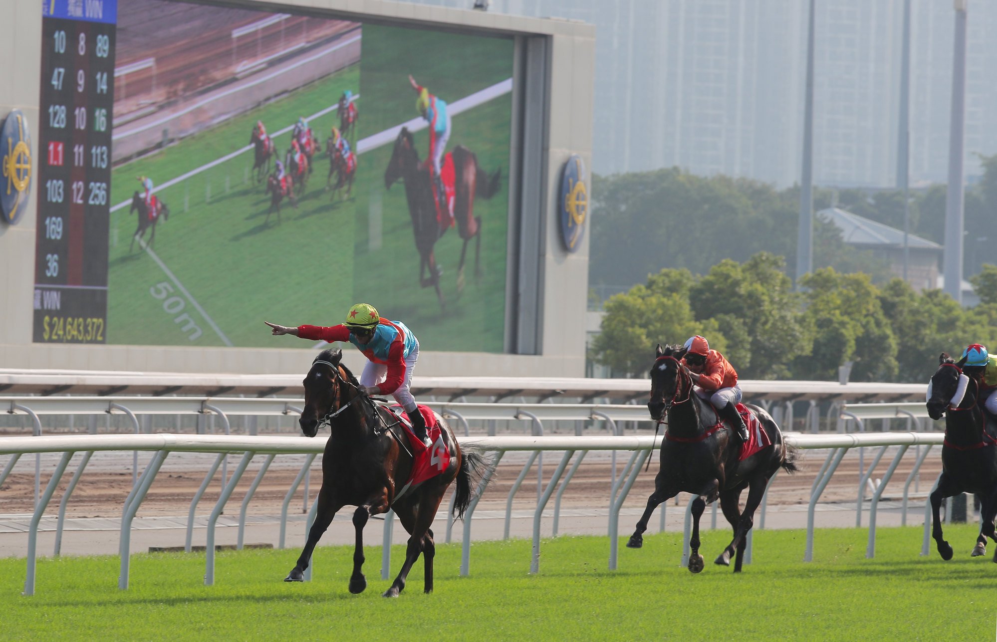 Zac Purton points to the camera after blowing a kiss as Ka Ying Rising makes a mess of his Jockey Club Sprint rivals.