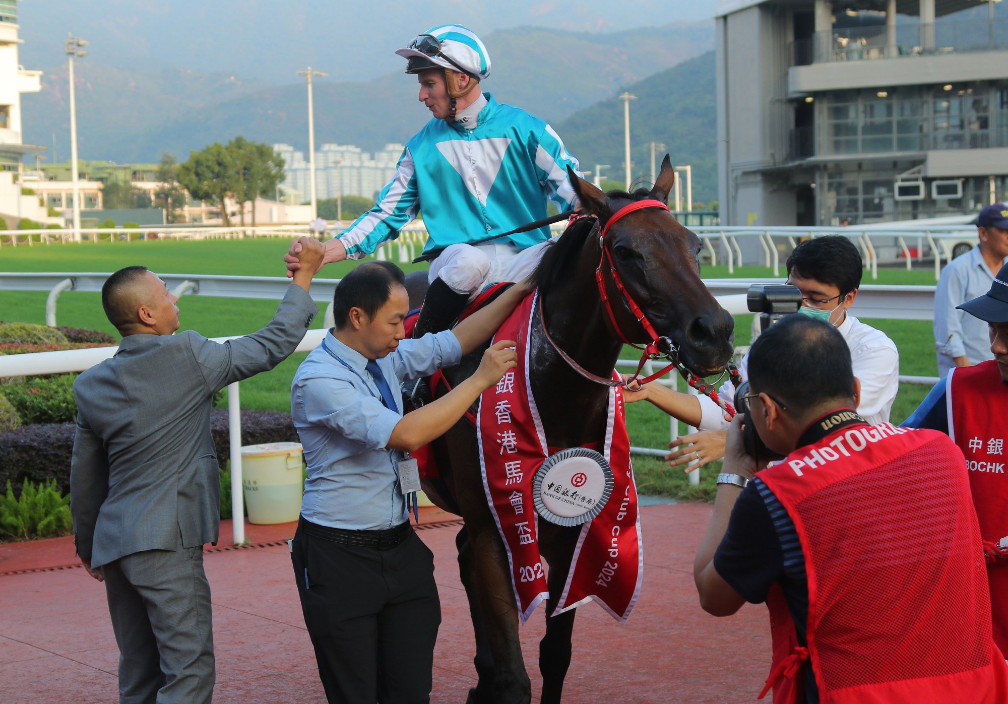 Trainer Danny Shum greets James McDonald and Romantic Warrior after his first-up win.