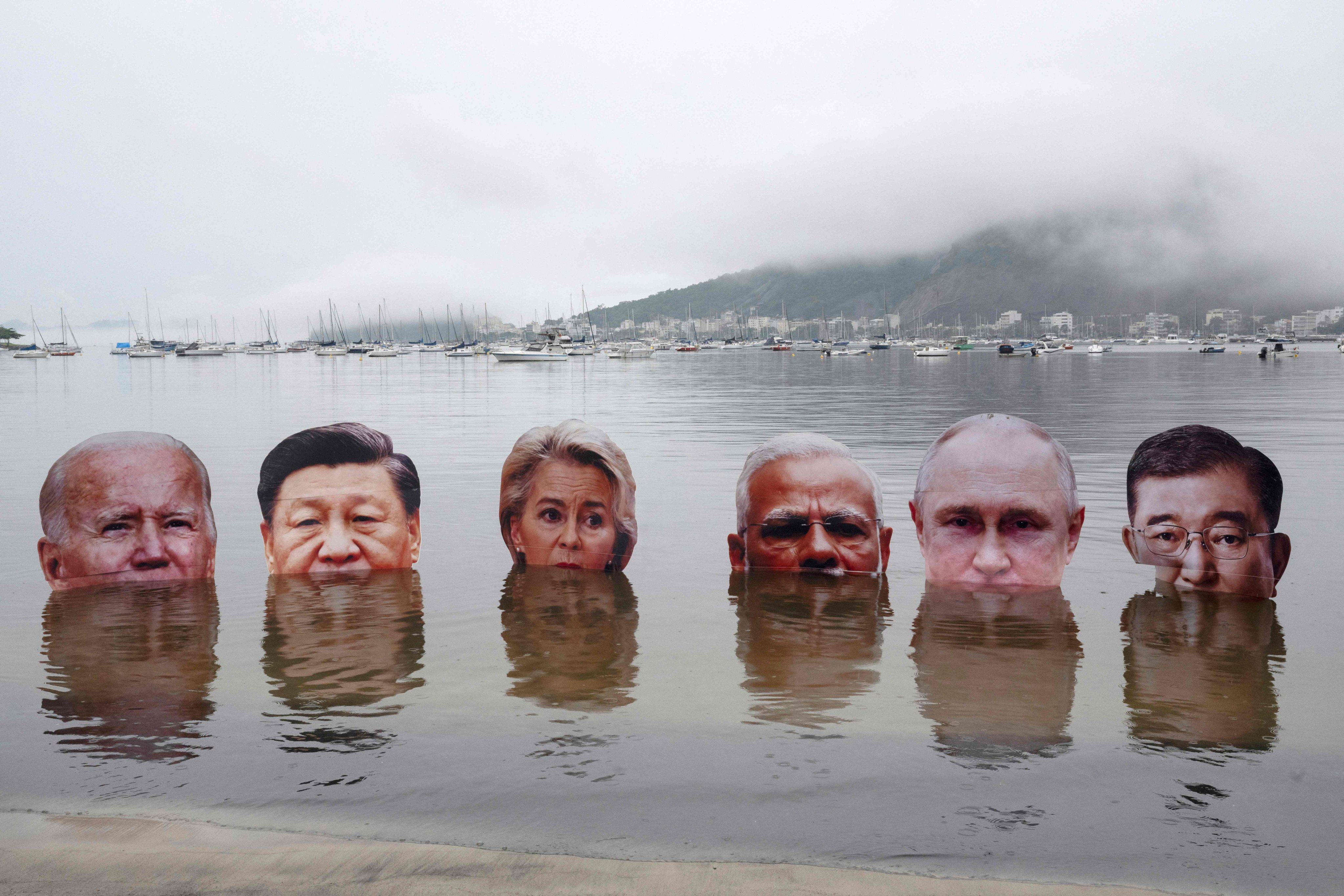 Giant portraits of (left to right) US President Joe Biden, China’s President Xi Jinping, President of the European Commission Ursula von der Leyen, India’s Prime Minister Narendra Modi, Russia’s President Vladimir Putin, and Japan’s Prime Minister Shigeru Ishiba, submerged by indigenous people to protest the lack of leadership among the world’s richest nations on addressing the anthropogenic climate and biodiversity crisis, in Rio de Janeiro, Brazil, on Saturday.