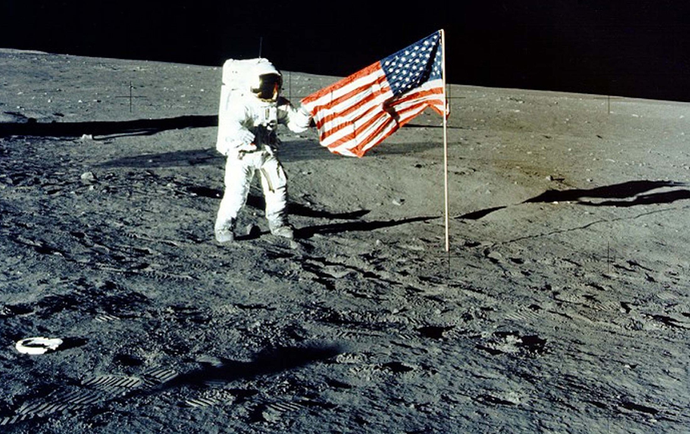 Charles “Pete” Conrad Jr stands with the US flag on the lunar surface during the Apollo 12 mission, in 1969. Photo: Nasa/Handout