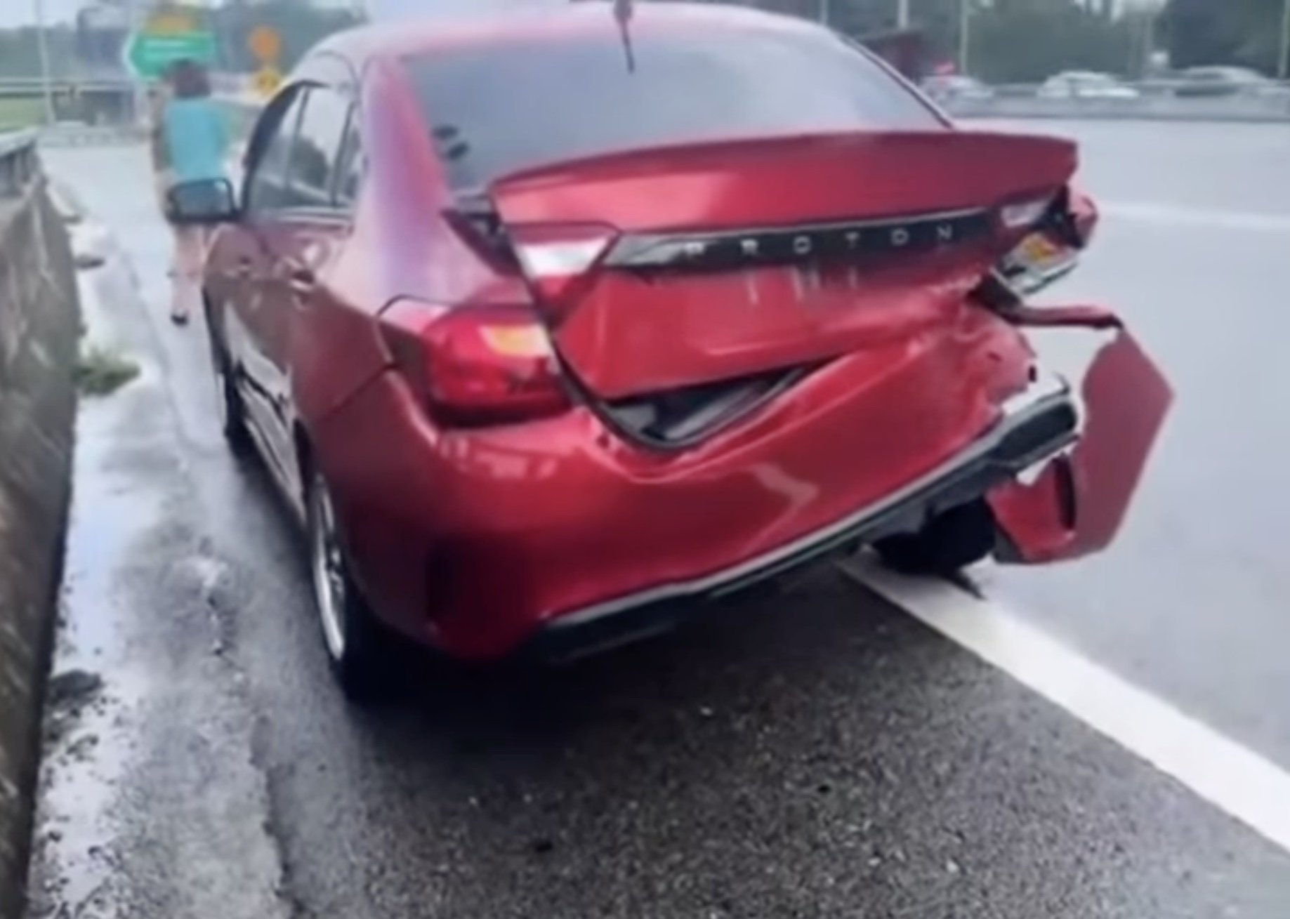 An accident in Malaysia involving a red car that was hit by a VIP convoy on a highway in Negeri Sembilan on Saturday. Photo: Bencana Malaysia/Facebook