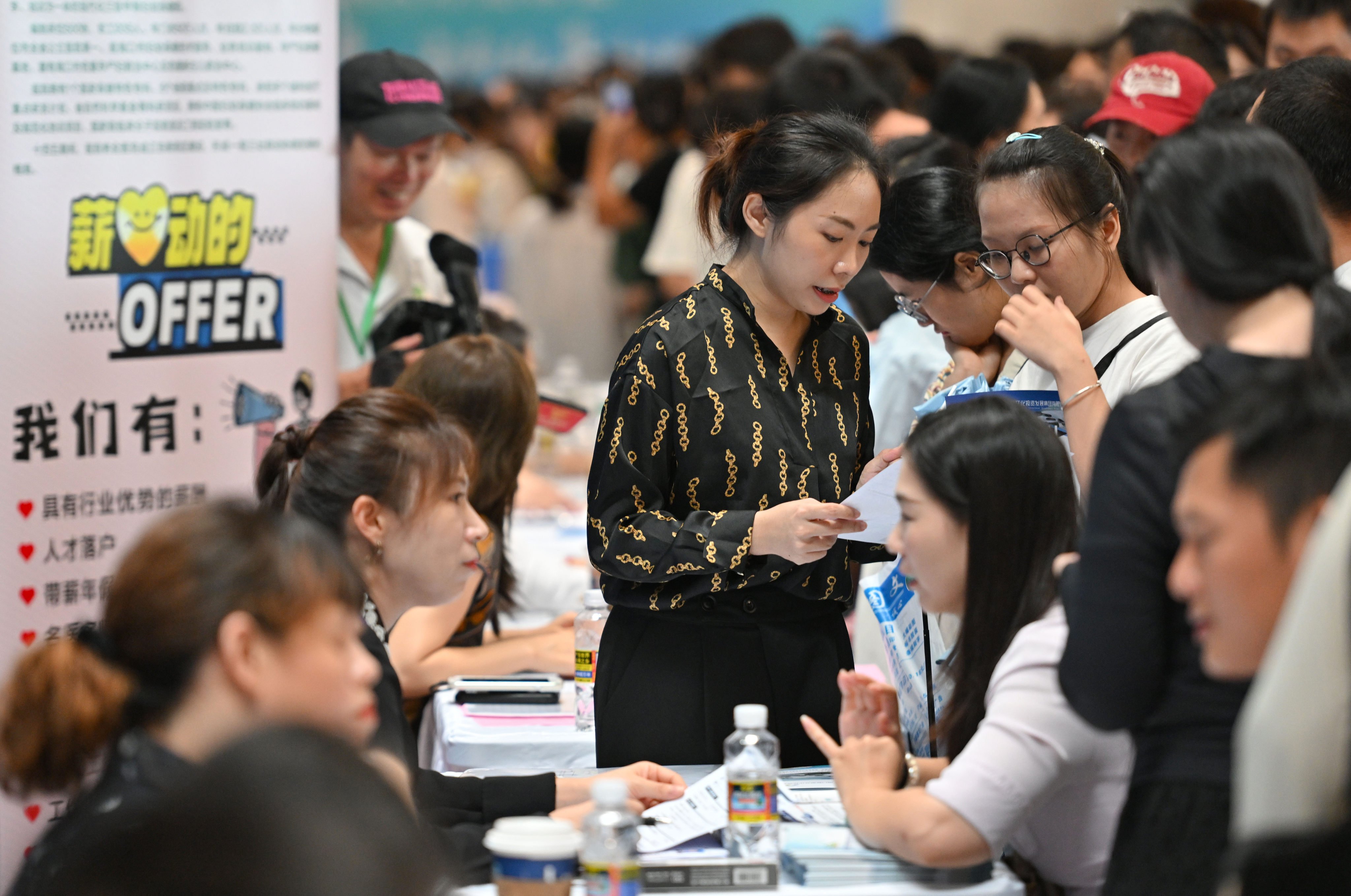 Job seekers talk with recruiting representatives at a job fair in Haikou, the capital of southern China’s Hainan province. Photo: Xinhua