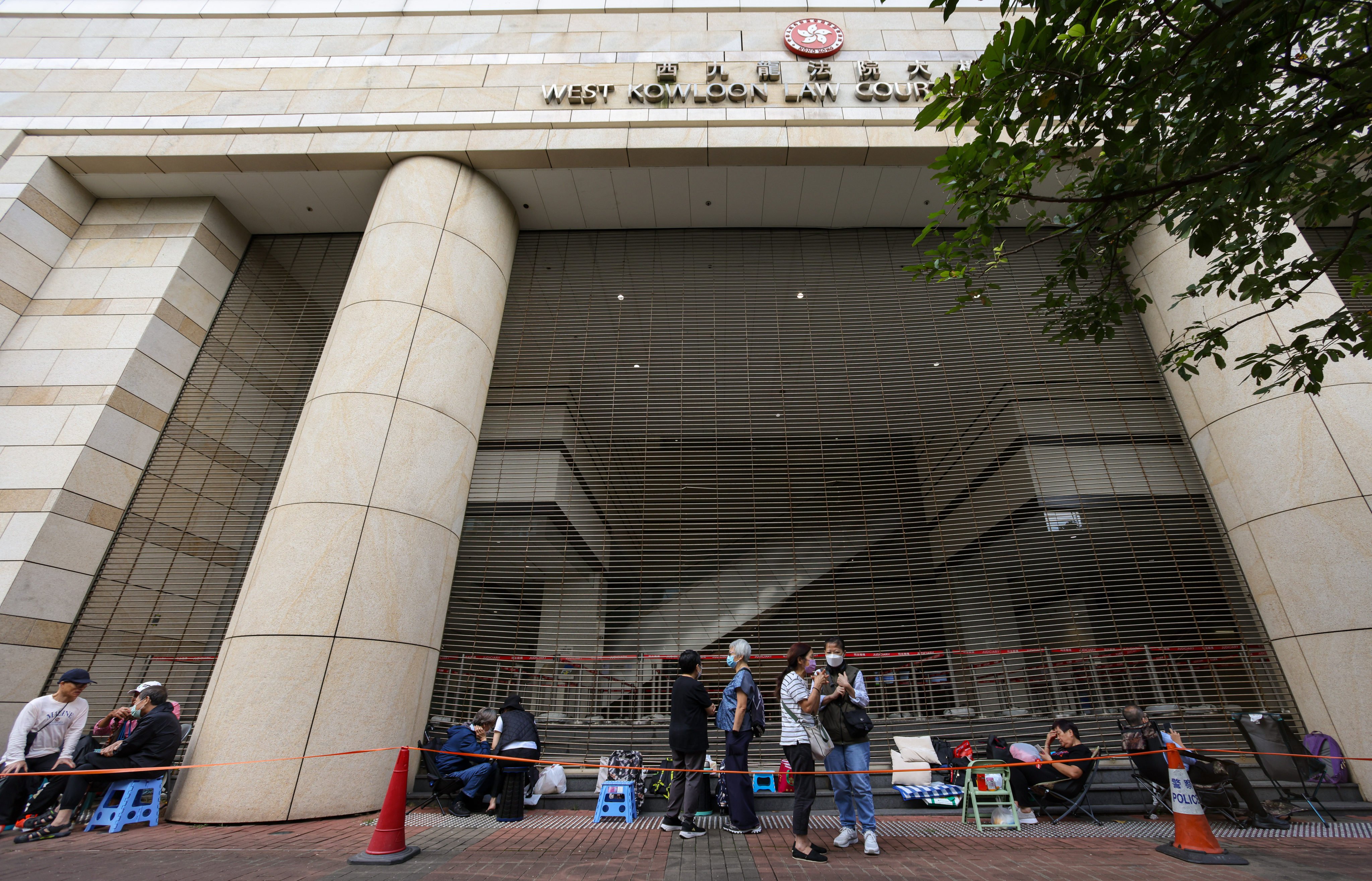 Dozens of residents queue outside West Kowloon Court in Cheung Sha Wan ahead of the sentencing hearing for 45 opposition figures. Photo: Eugene Lee