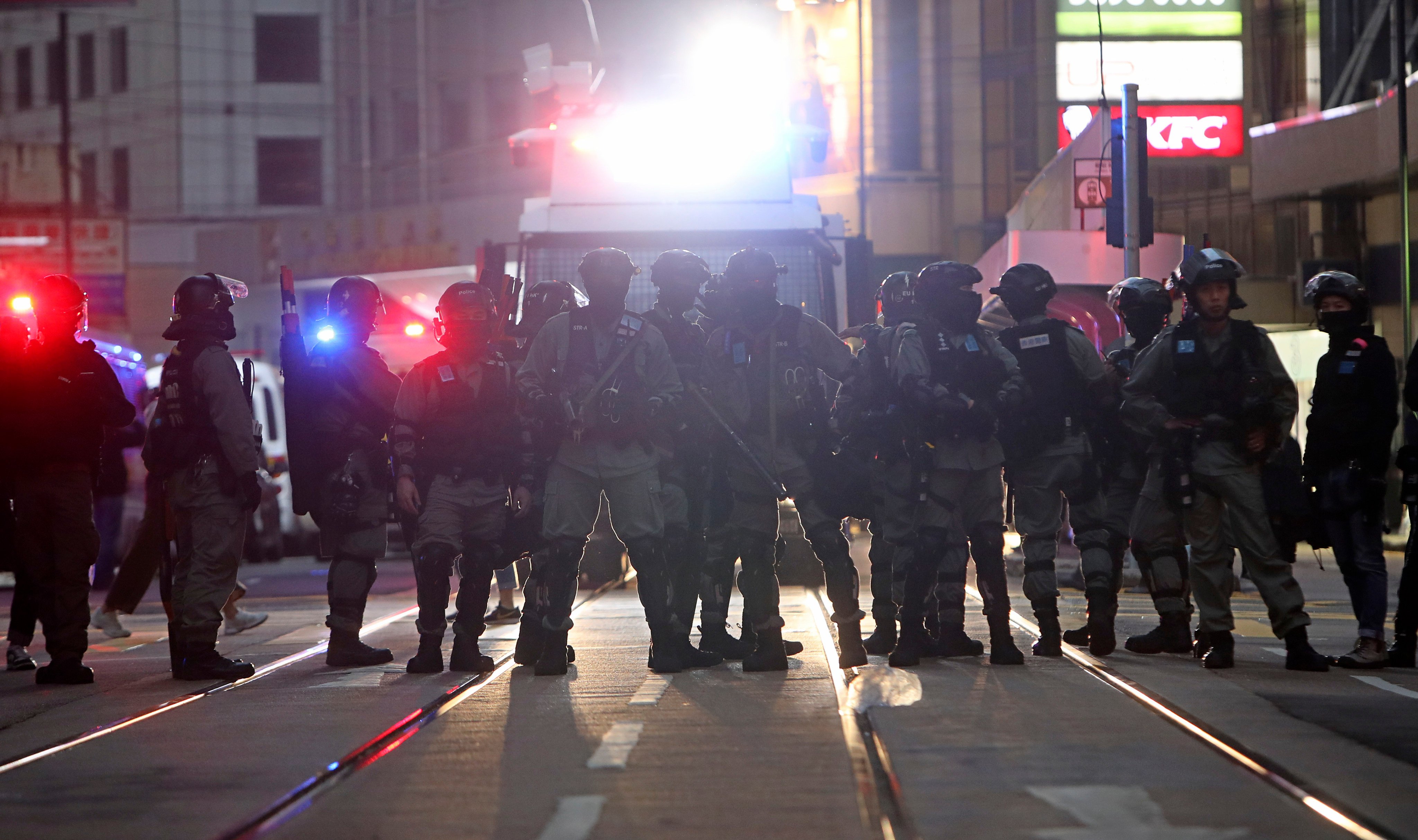 Police officers keep watch as protesters take to the streets on December 8, 2019. Photo: Winson Wong