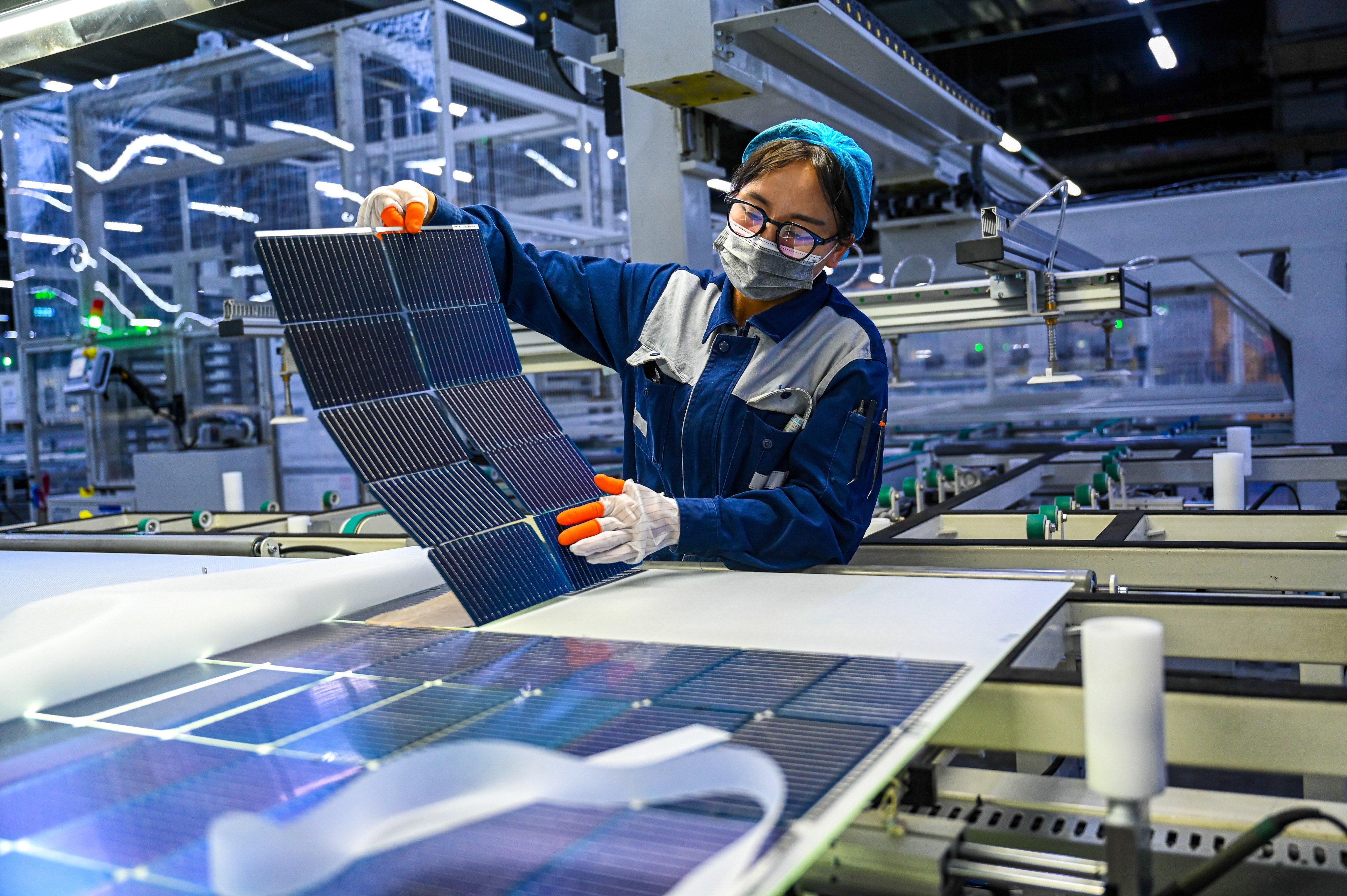 A worker checks monocrystalline silicon wafers at a solar-panel production facility in China earlier this year. Photo: Xinhua