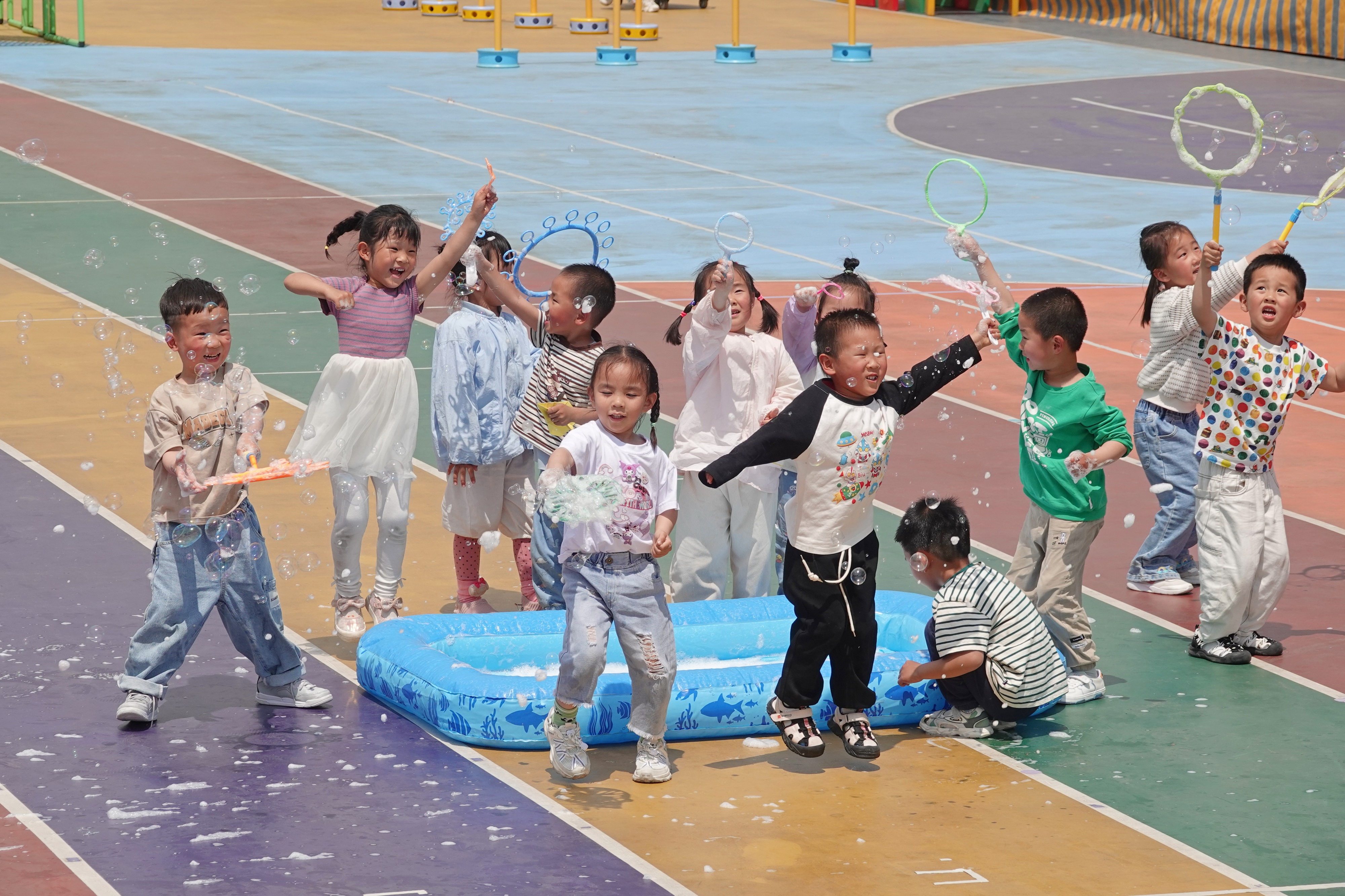 Children play with bubbles at a kindergarten in Yantai Hi-tech Zone in eastern China’s Shandong province. Photo: Future Publishing via Getty Images