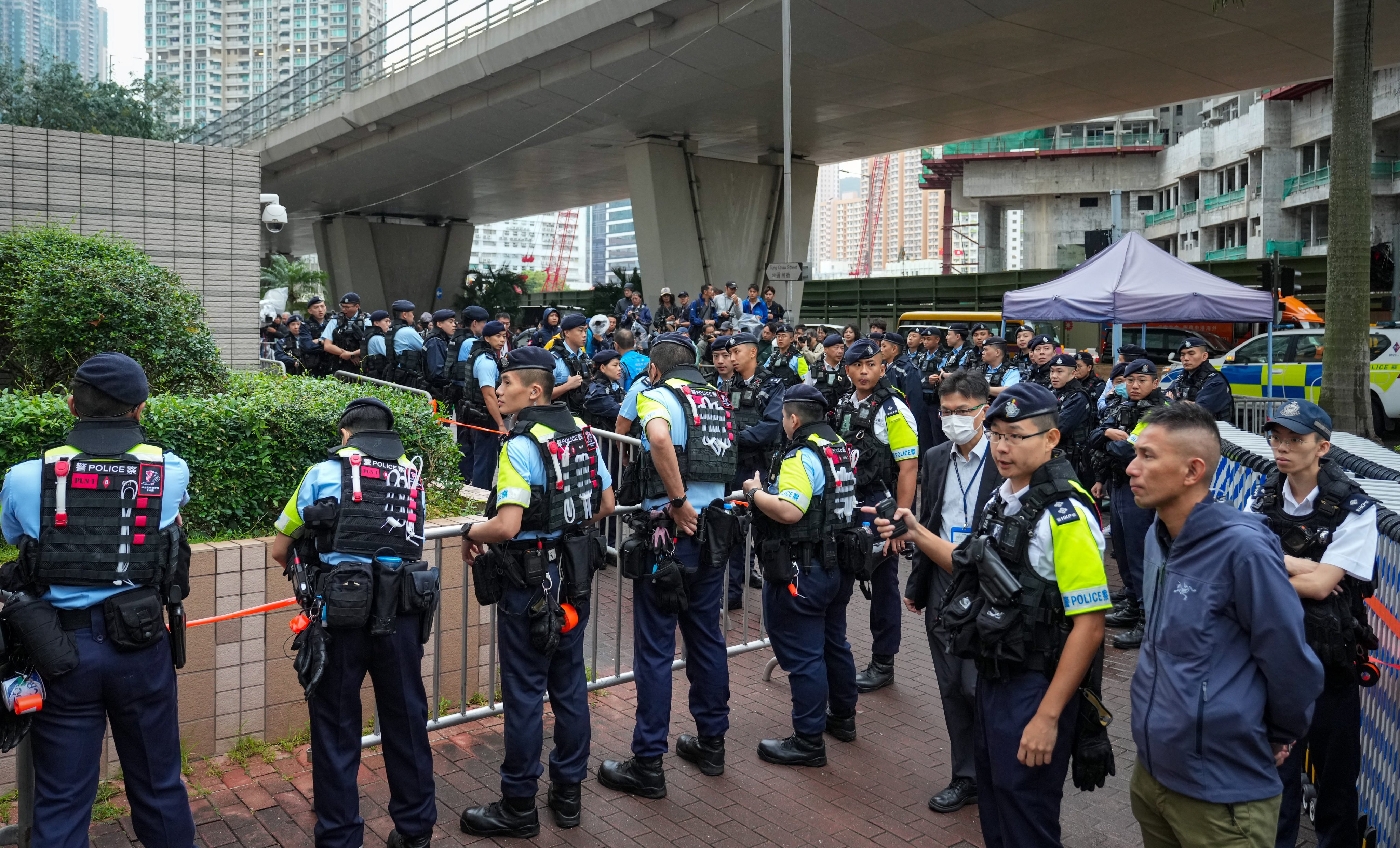 Police stand guard outside West Kowloon Court as Hong Kong’s landmark subversion trial draws to a close. Photo: Sam Tsang