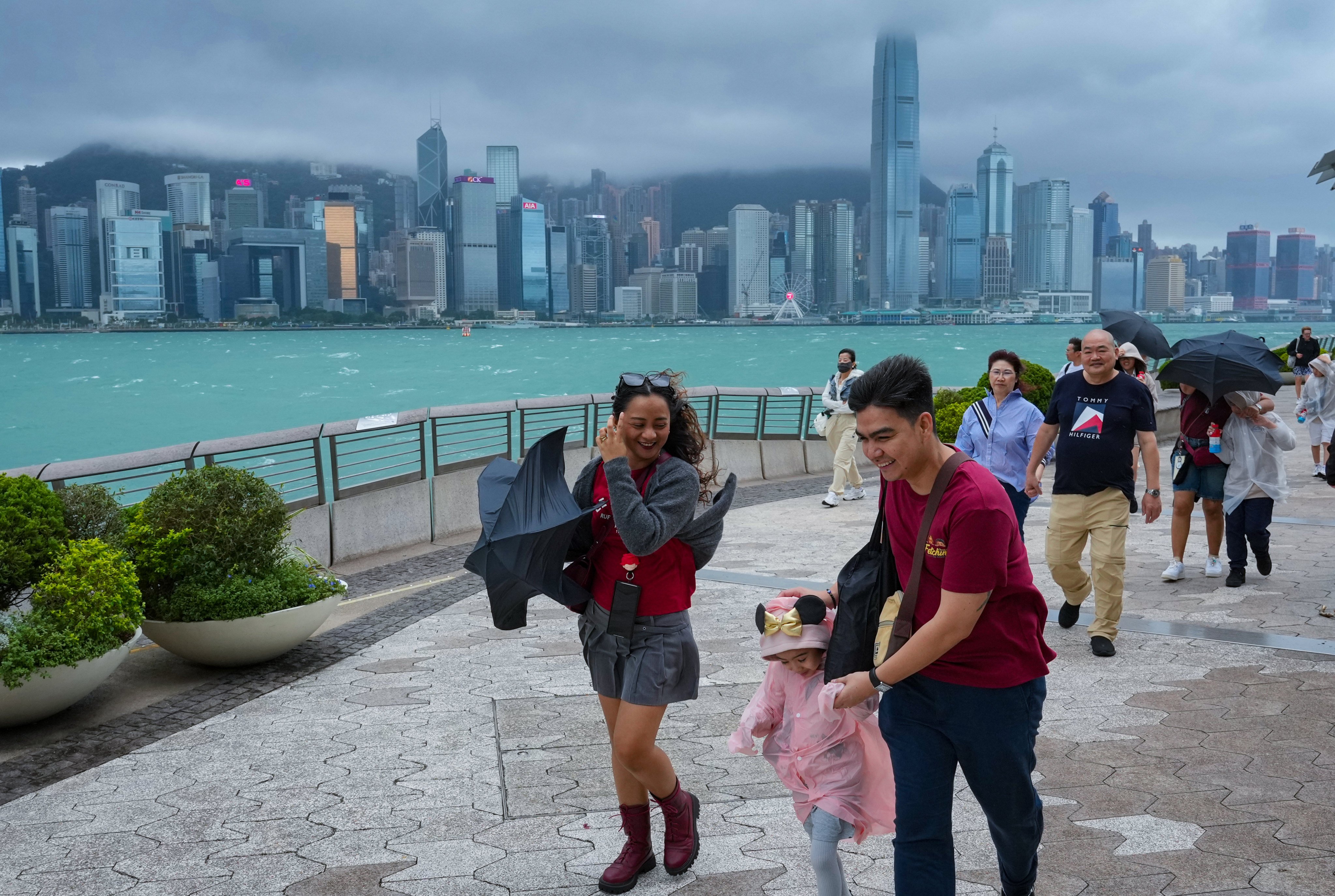 Tourists enjoy a breezy stroll along the Tsim Sha Tsui waterfront.    Photo: May Tse